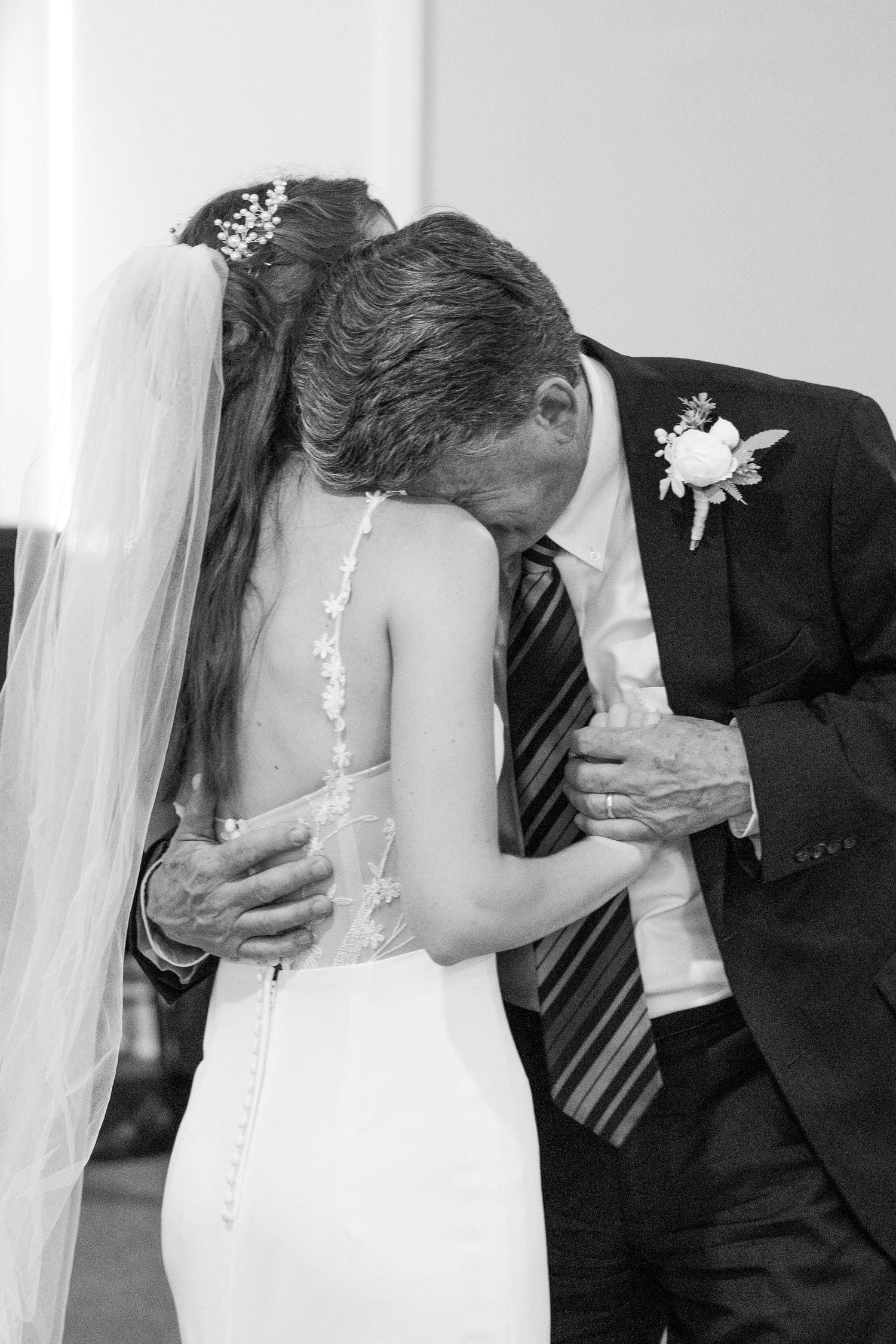 dad crying on bride's shoulder during daddy-daughter dance