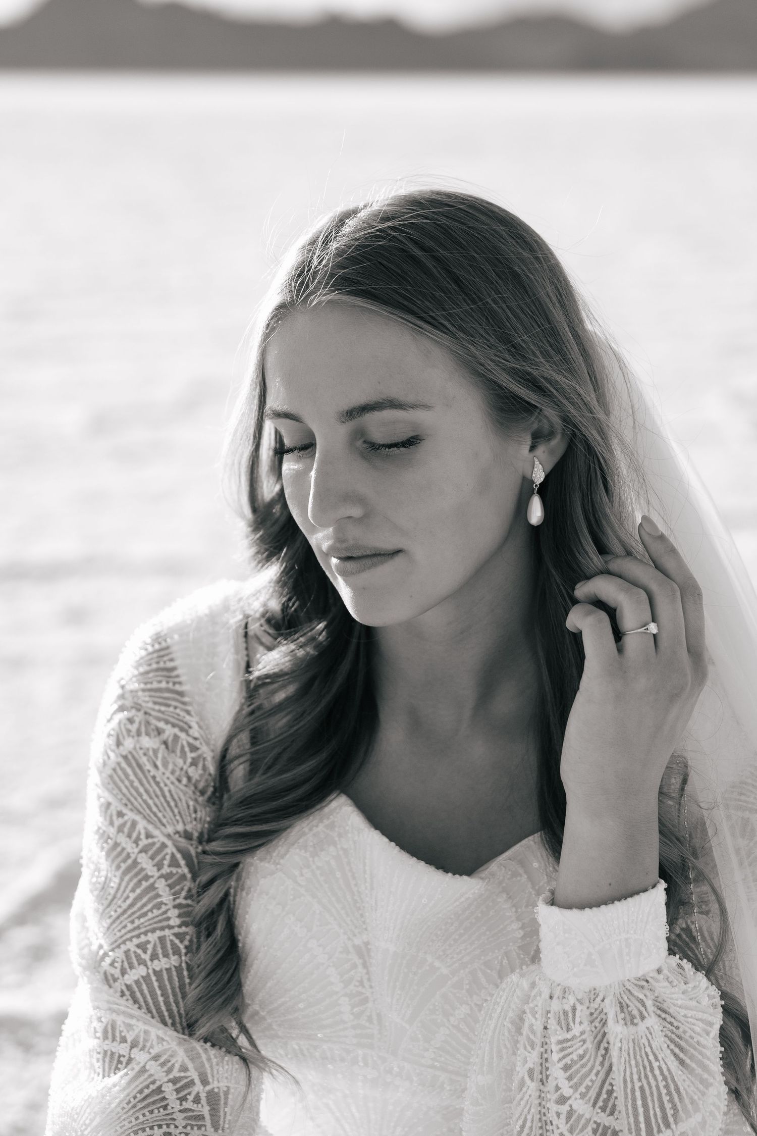 bride on the Utah salt flats showing off her earrings