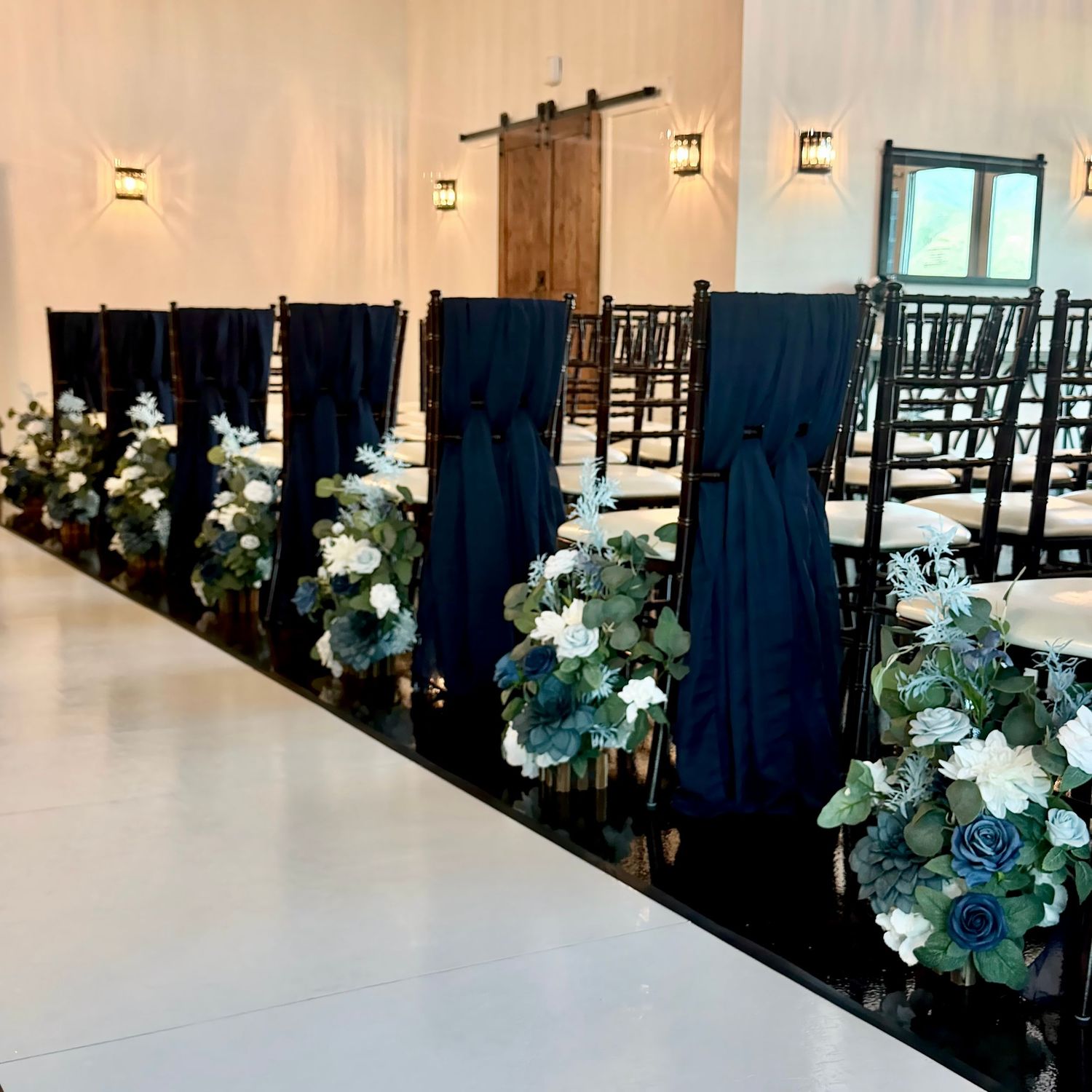 image of the event hall at The Southern Chateau Wedding Venue in Payson, Utah County, Utah, and its blue aisle florals