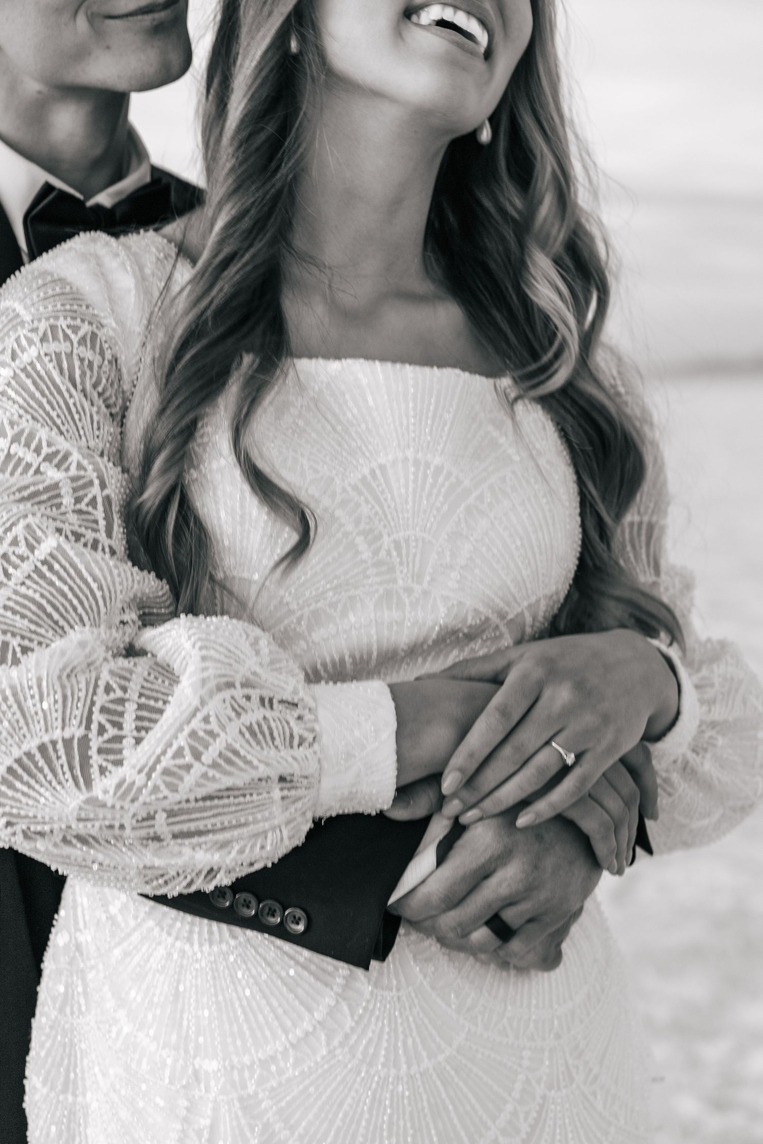 couple embracing on the Utah salt flats at sunset in black and white