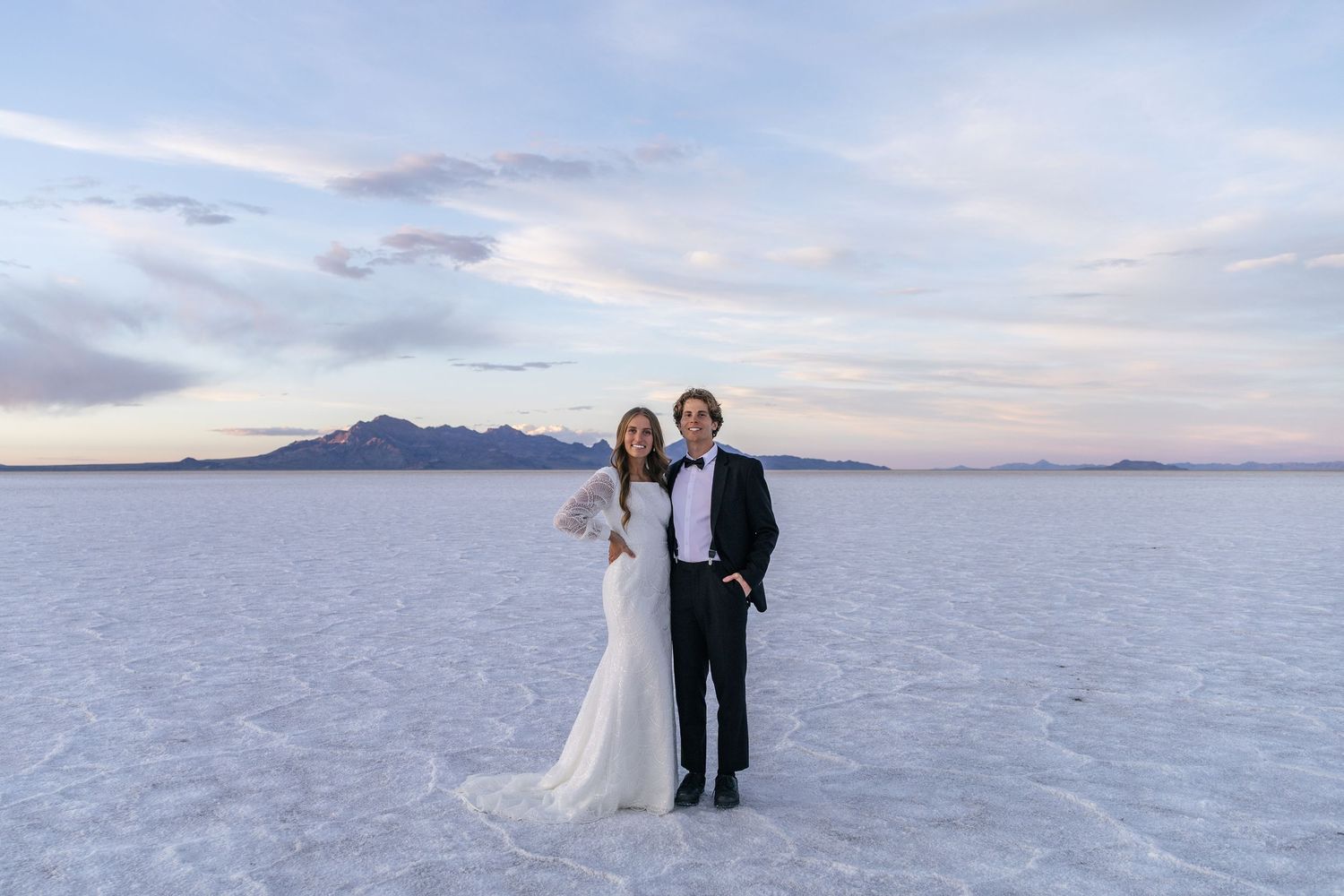 couple posing on the Utah salt flats at sunset