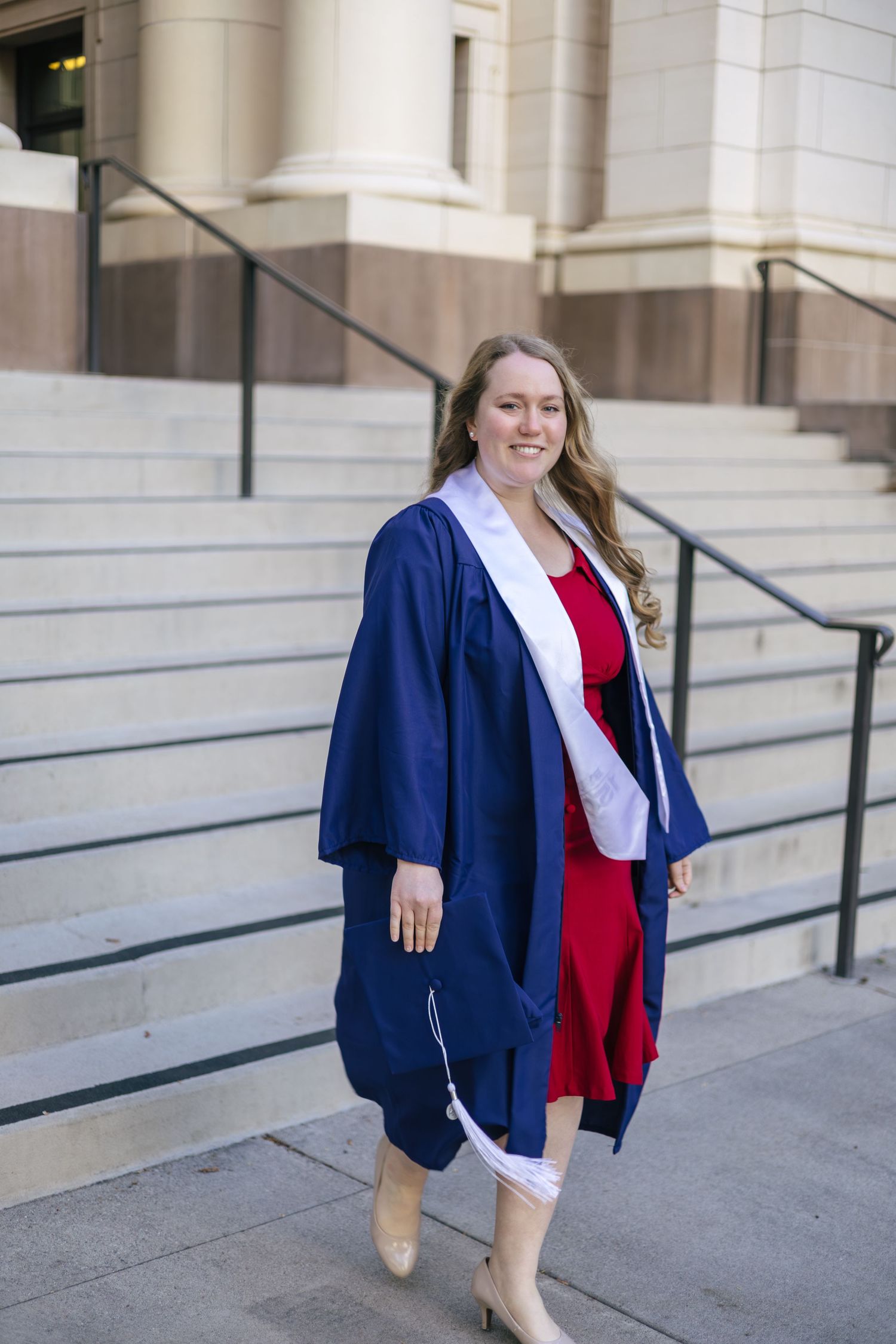 byu graduate walking down steps on campus