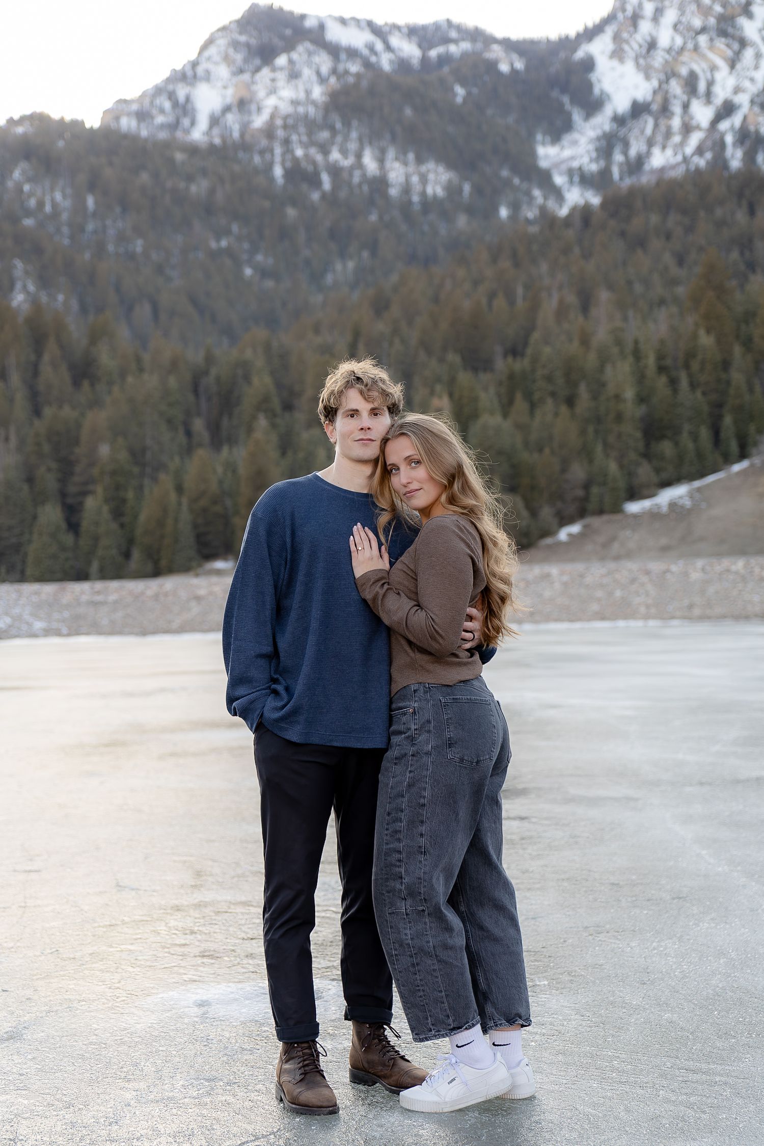 couple on the ice in provo canyon taking engagement photos