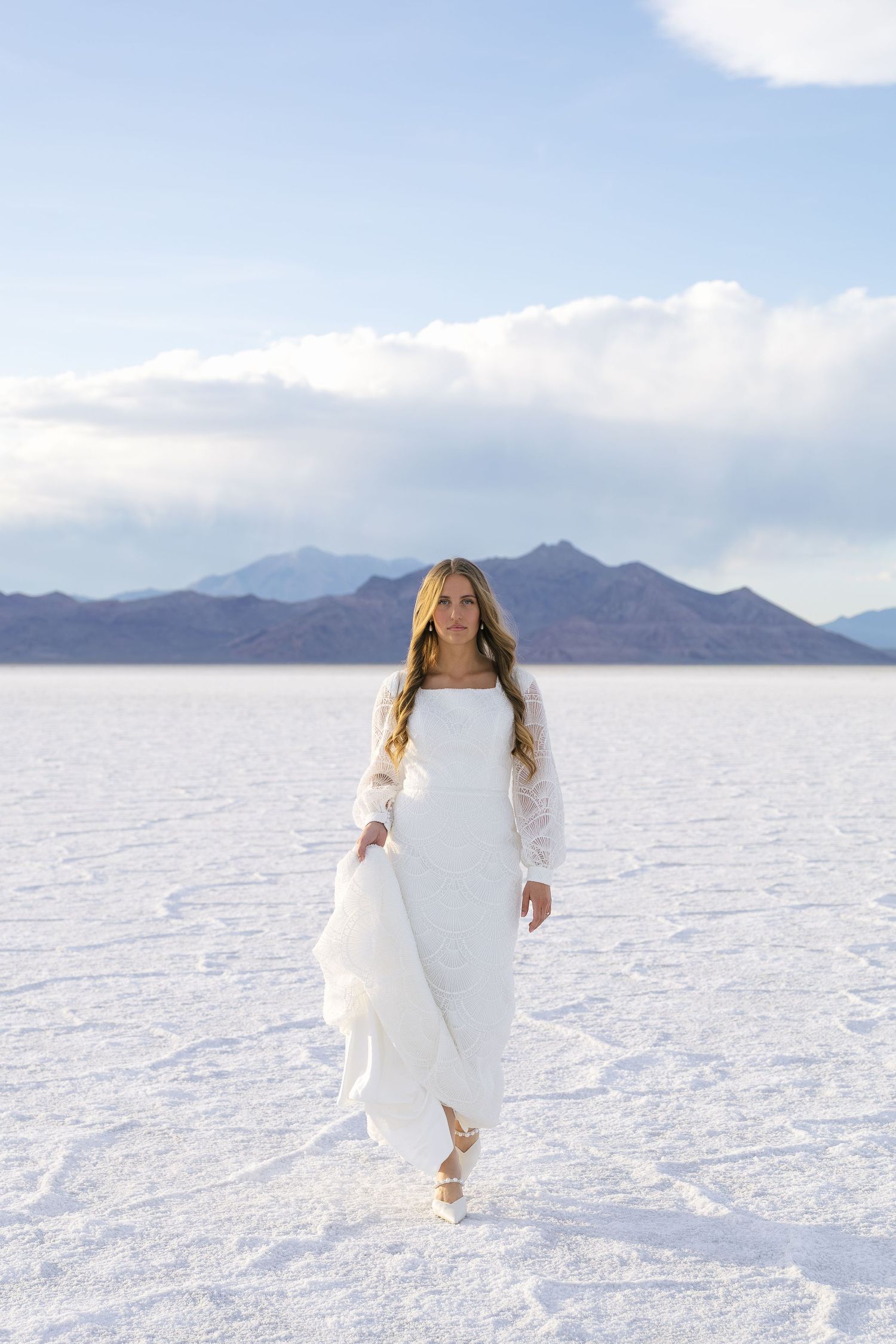 bride on the Utah salt flats walking toward the camera