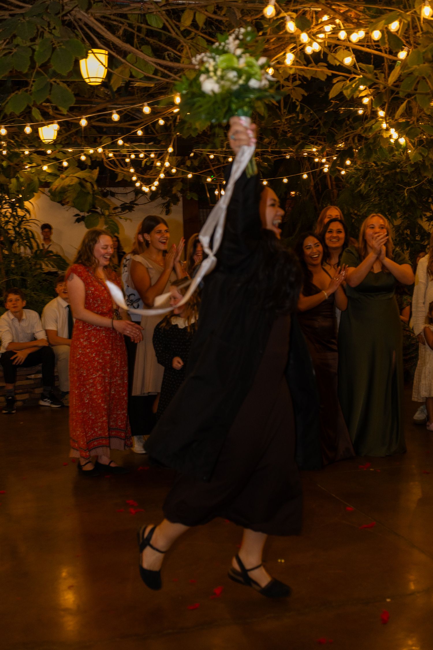 woman catching bridal bouquet