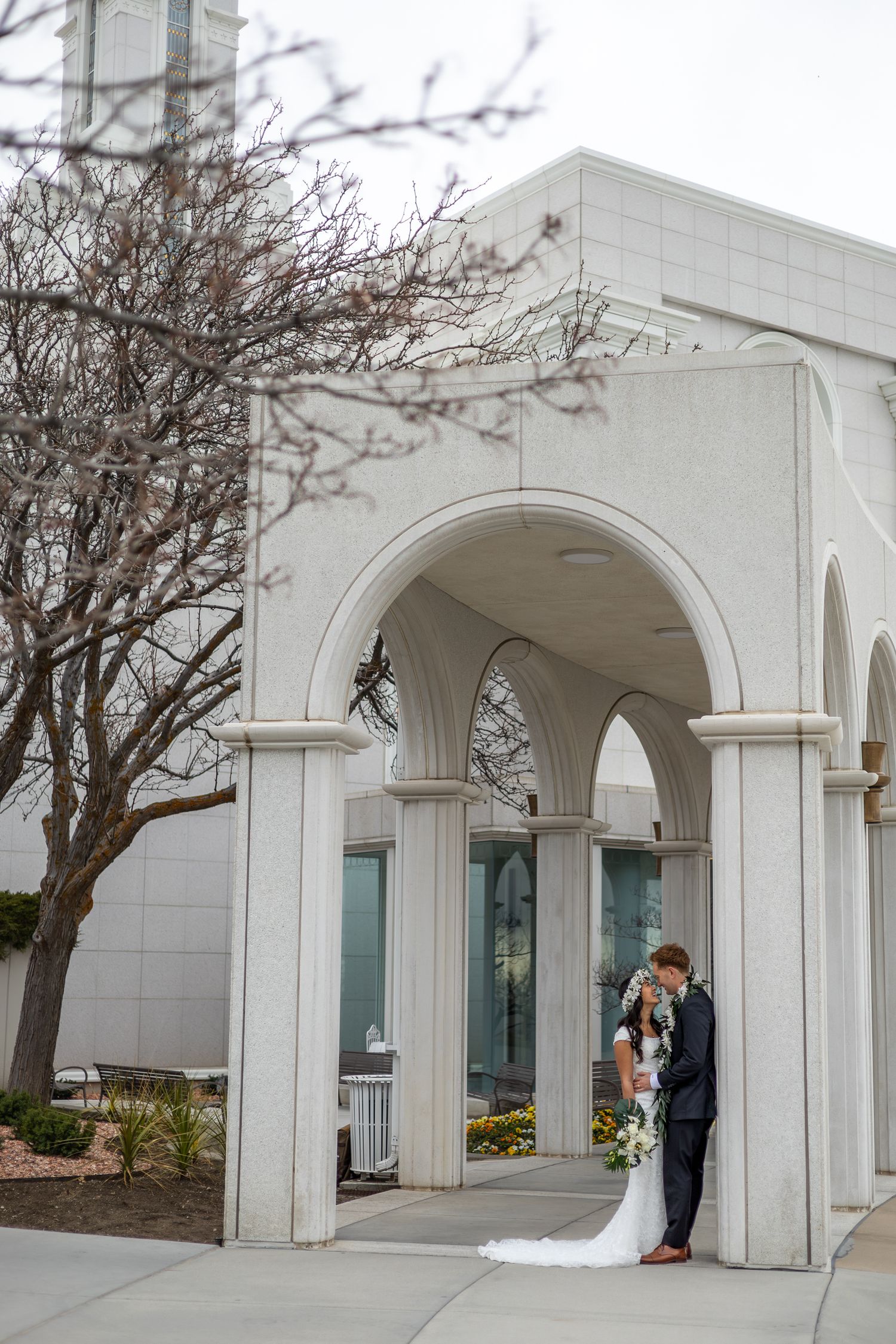couple outside an LDS temple after wedding ceremony in utah