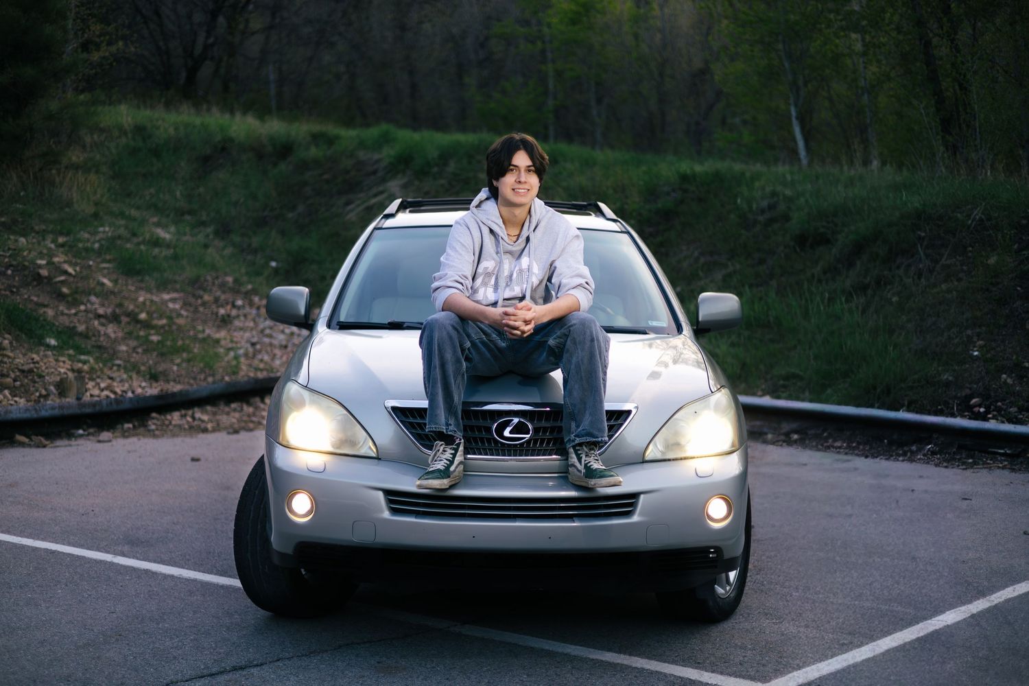 senior boy sitting on his car for a senior picture session