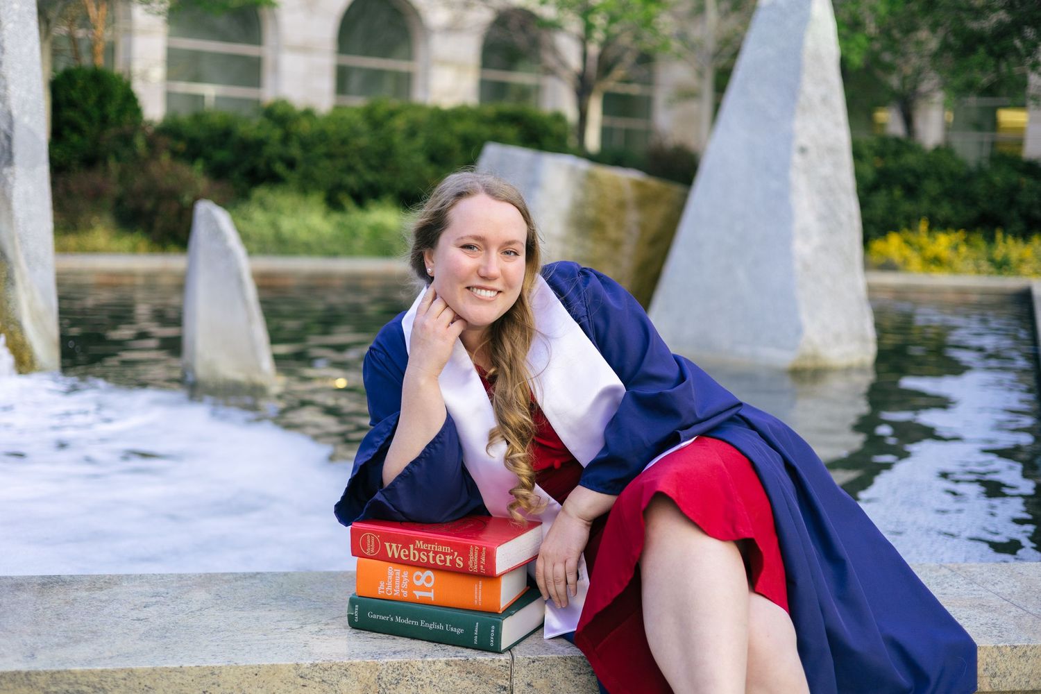 byu graduate posing in front of fountain