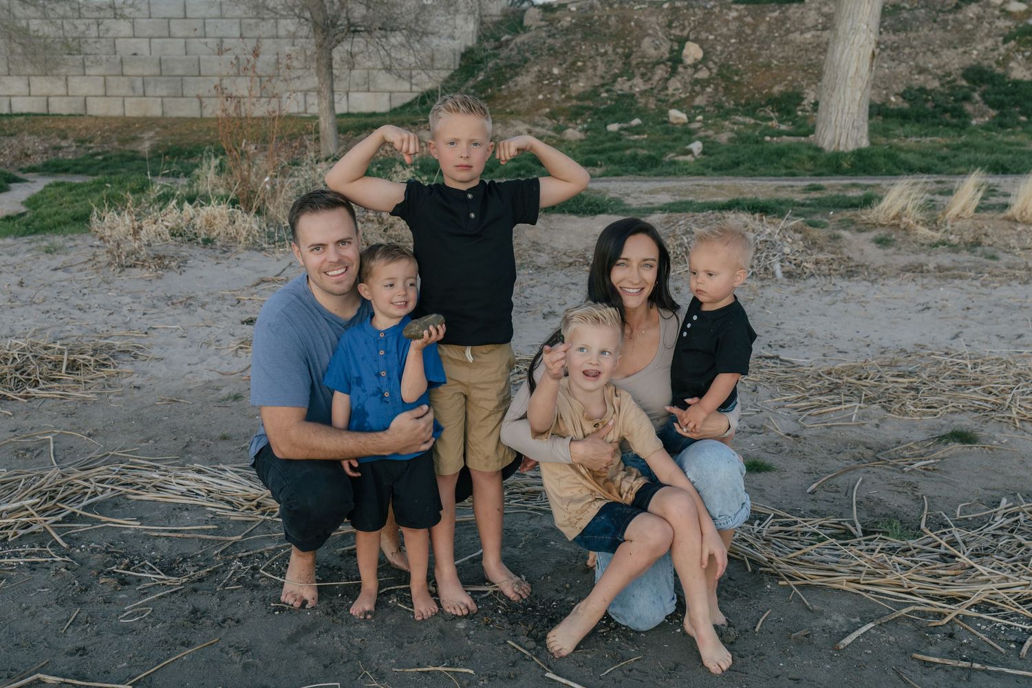 family photos at utah lake at sunset, posing by the water