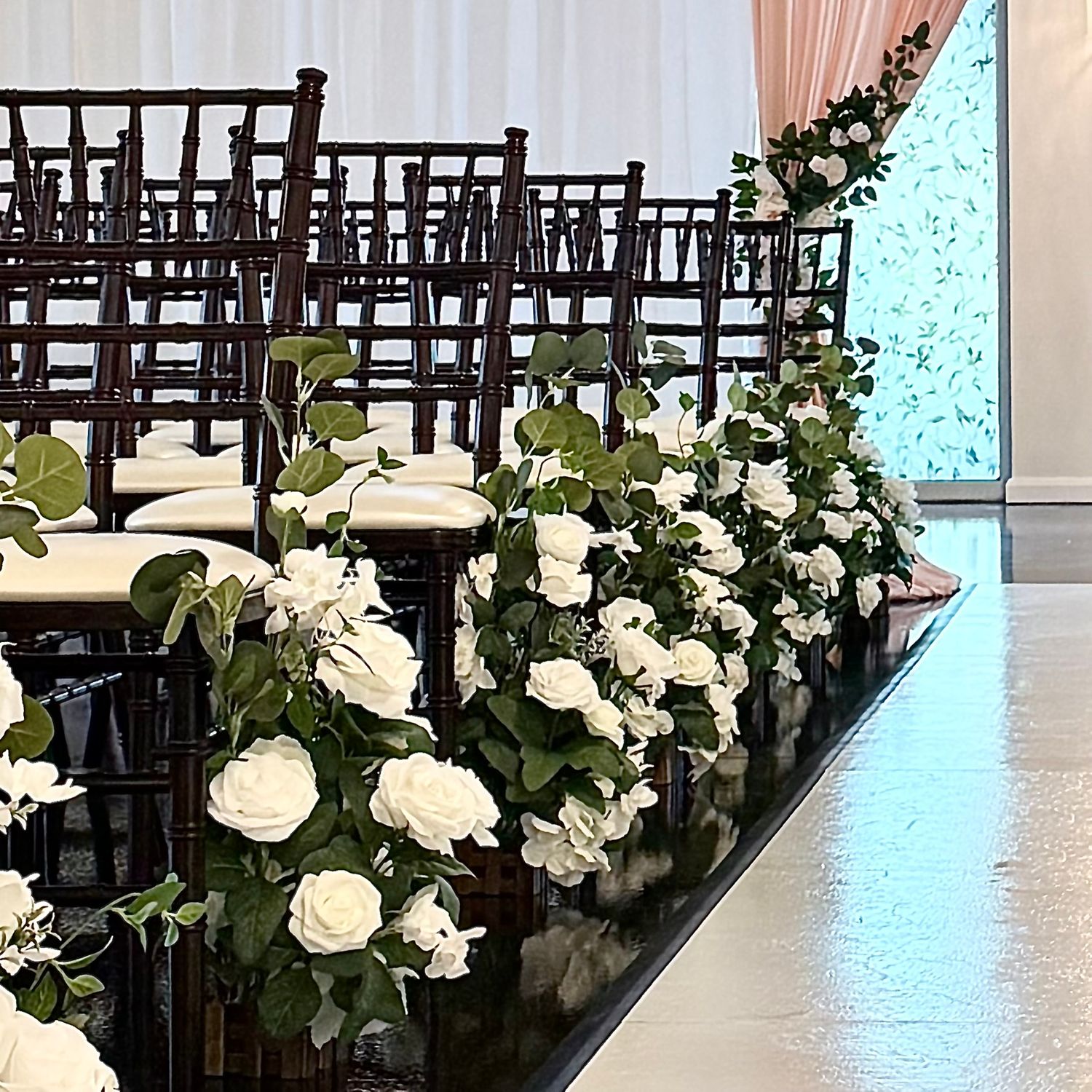 image of the event hall at The Southern Chateau Wedding Venue in Payson, Utah County, Utah, and its white rose aisle florals