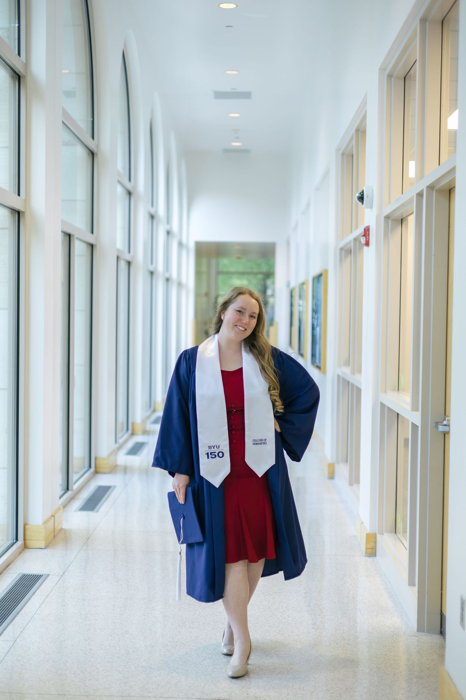 byu graduate posing inside a campus building