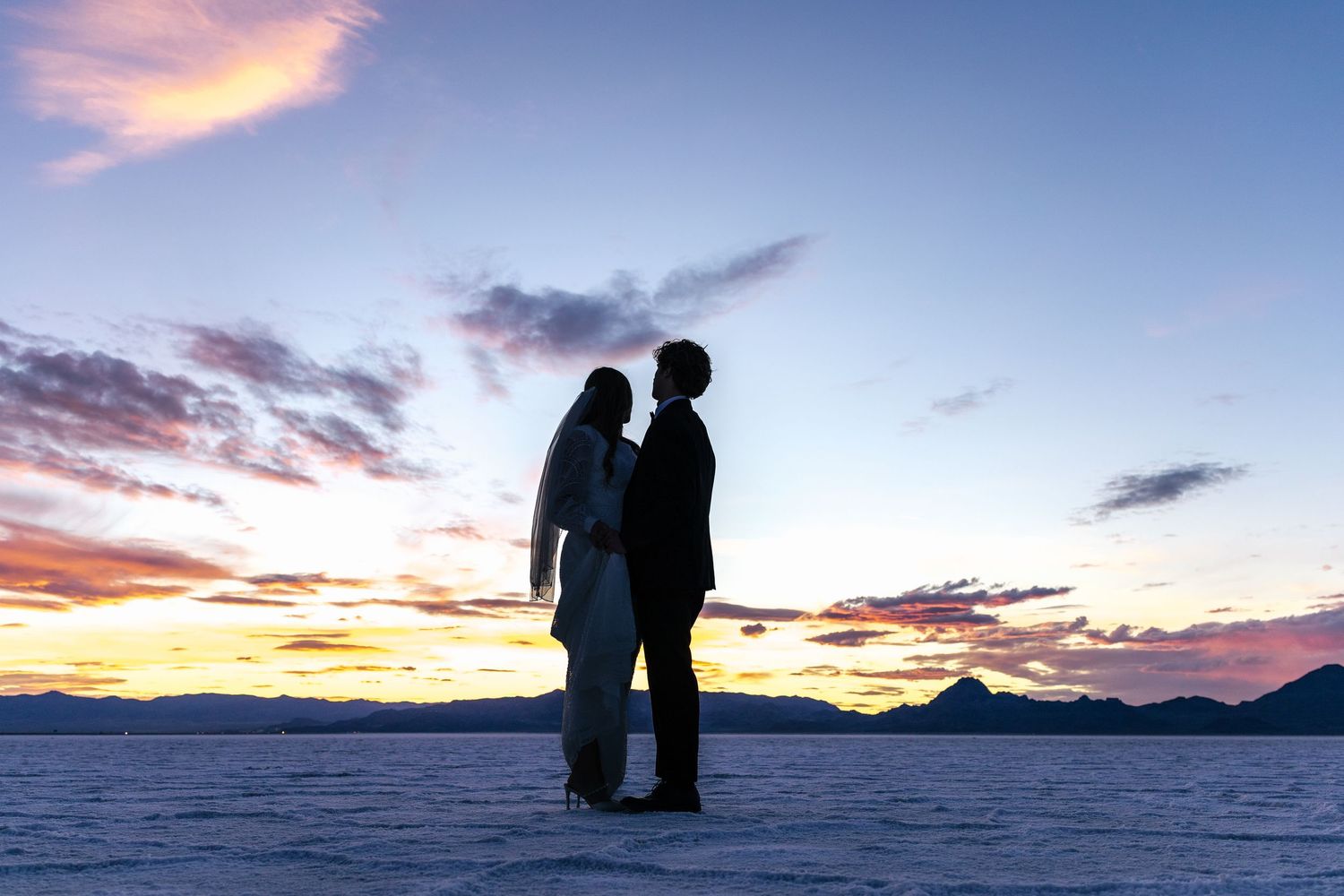 couple dancing on the Utah salt flats after sunset
