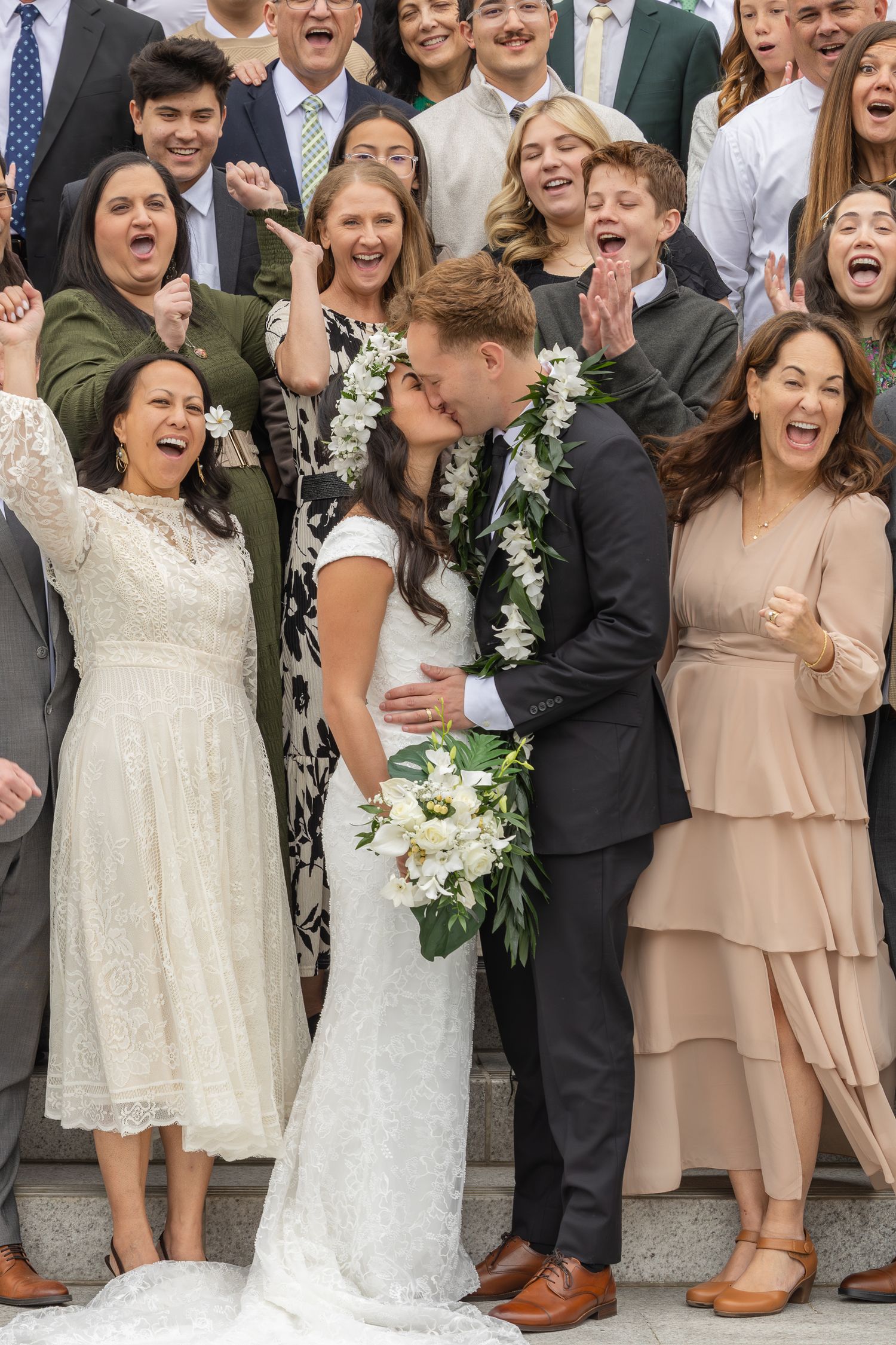 couple taking pictures with family outside an LDS temple after wedding ceremony in utah