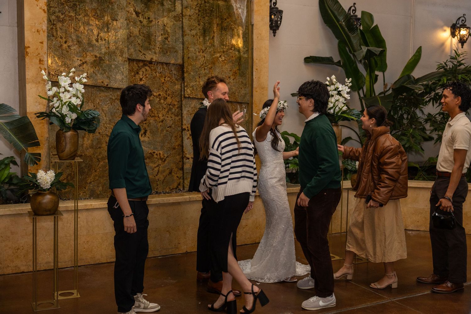 married couple greeting guests at wedding reception