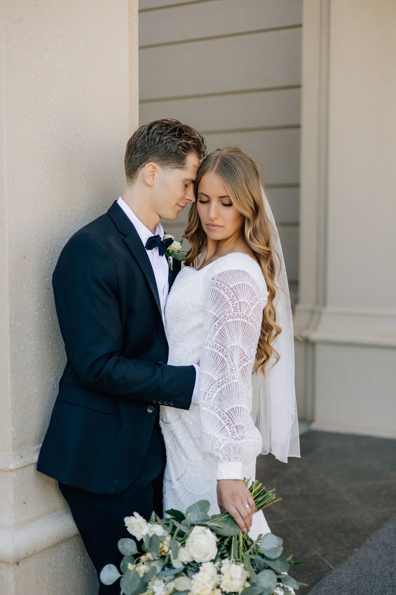 bride and groom at the payson utah lds temple on their wedding day, posing for formal couples' pictures after their marriage in the temple