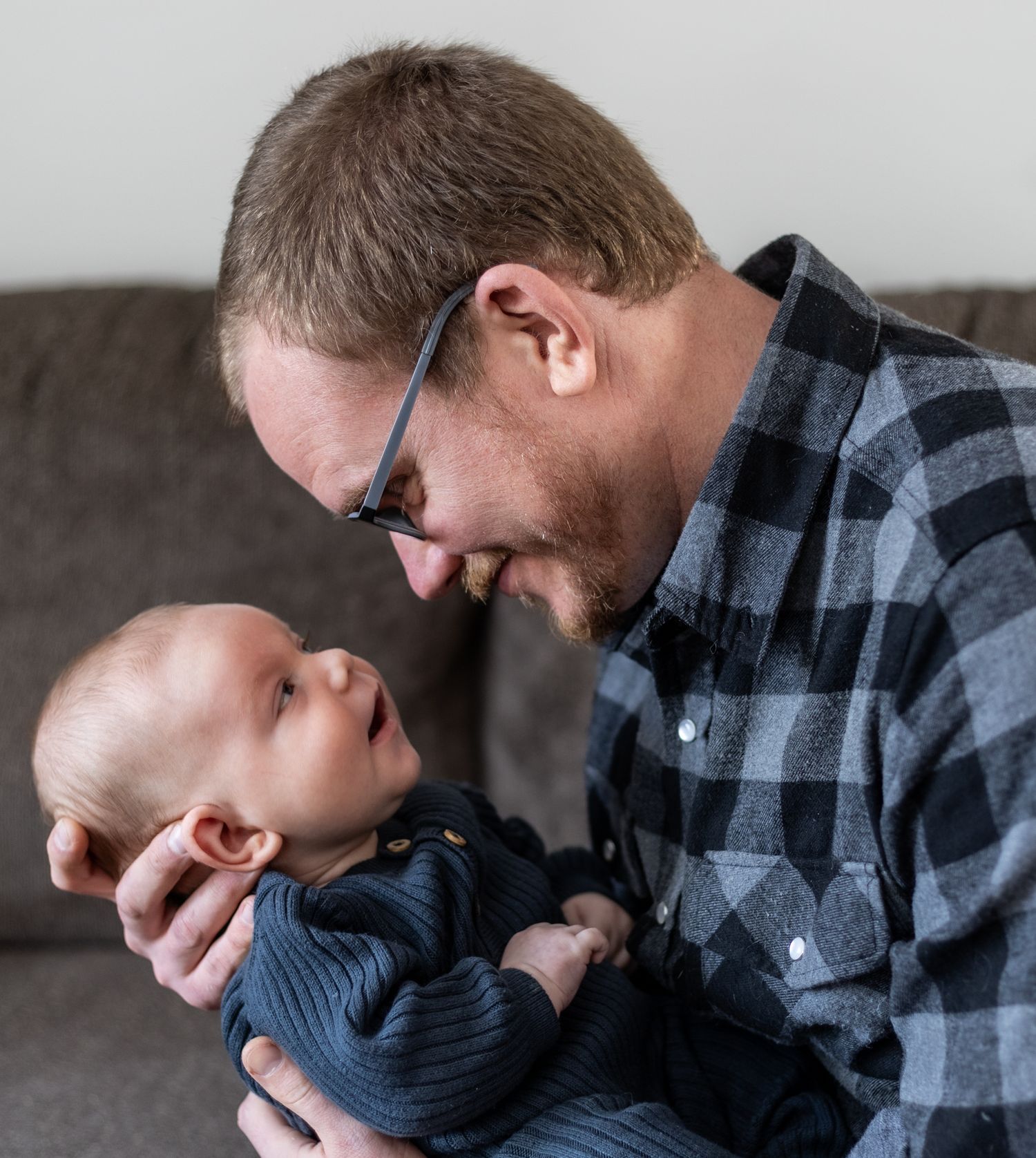 A father and baby share tender emotional moments in a series of black and white photographs. Cincinnati/ Northern Kentucky newborn lifestyle