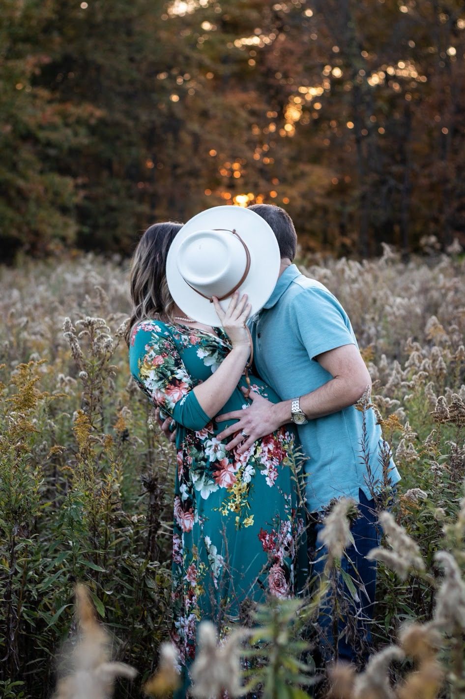 A couple shares a romantic moment in a field of wildflowers during golden hour sunset. Cincinnati Nature Center