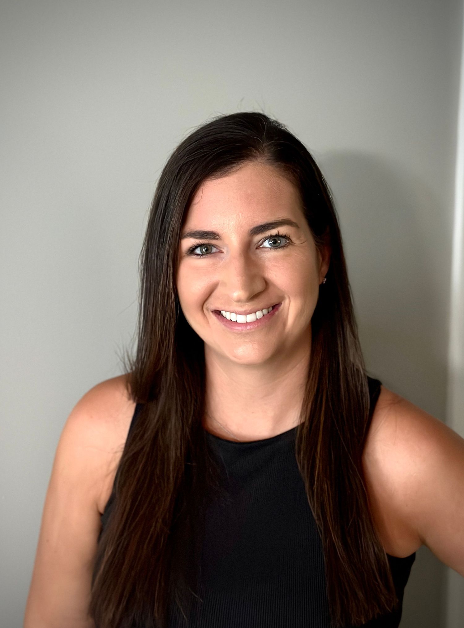 A headshot showing a person with dark hair and a black sleeveless top. Cincinnati/ Northern Kentucky