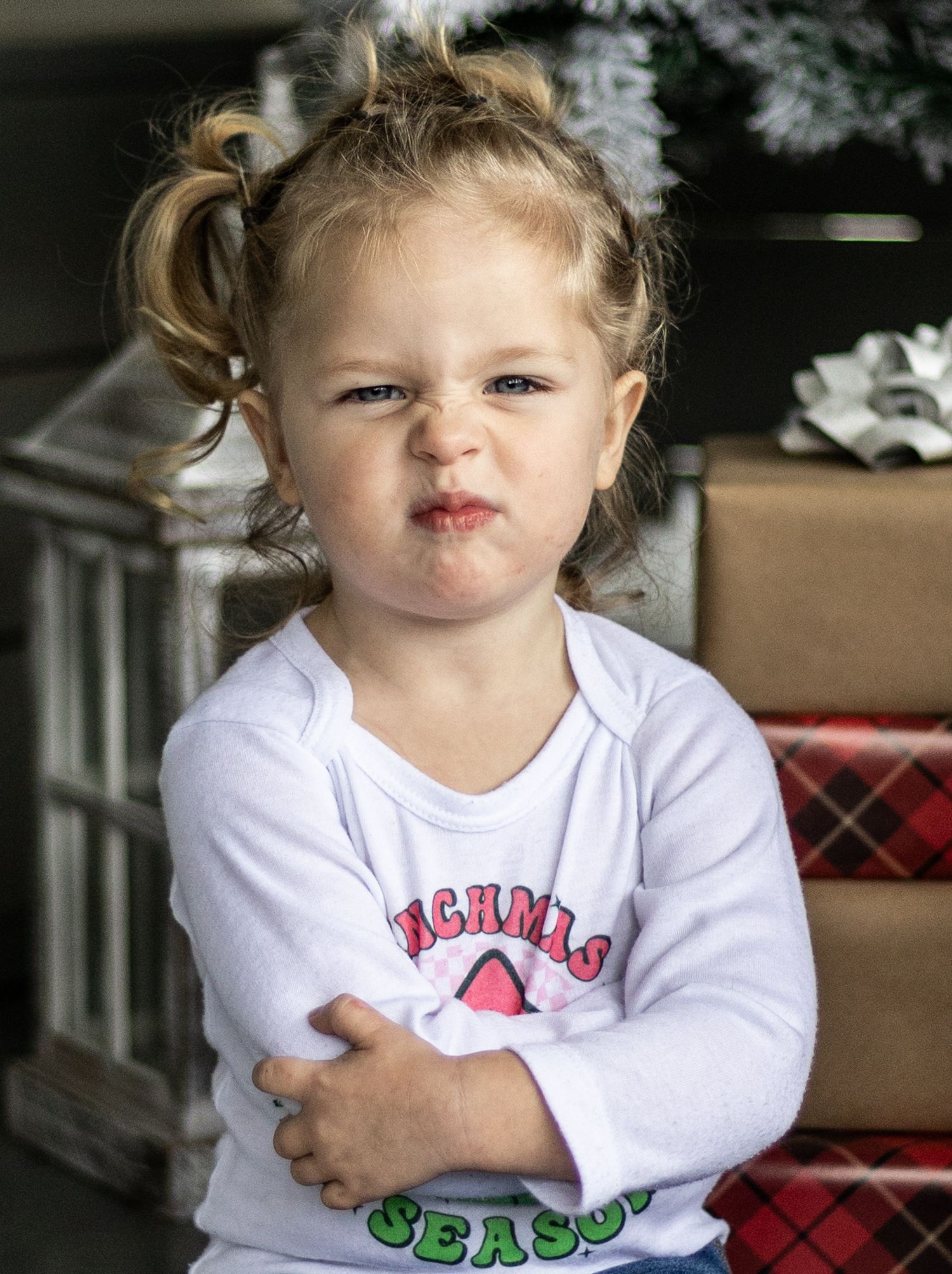 A sequence of photos showing a young child in a white shirt making expressive faces and poses.