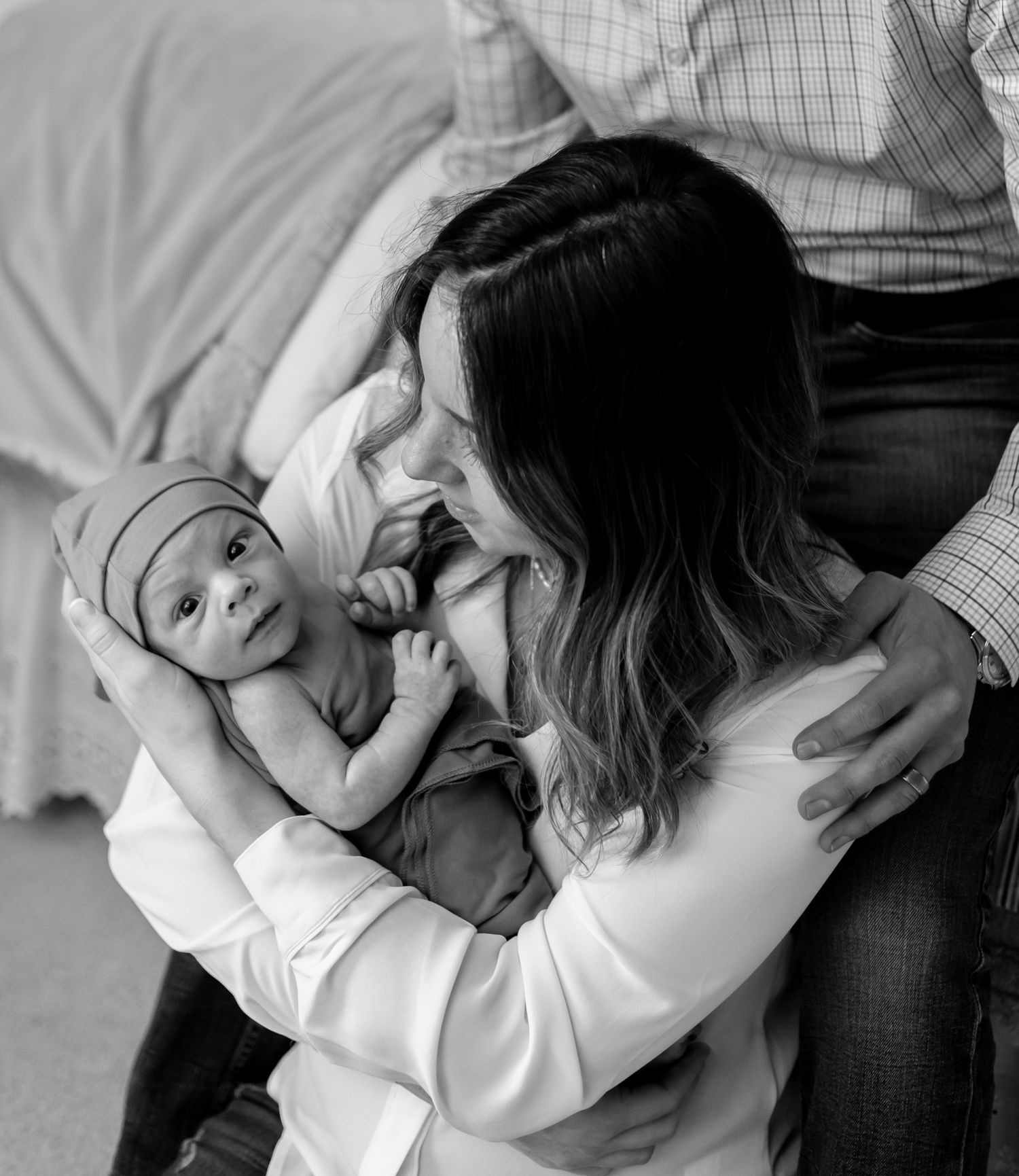 Black and white sequence of photos showing a couple playfully interacting on a couch. Cincinnati/ Northern Kentucky