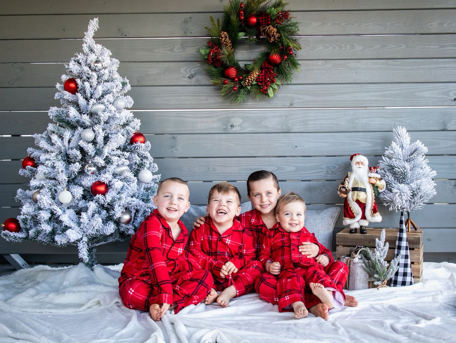 A festive holiday photo collage with snow-flocked trees, red decorations, and a rustic gray wood panel backdrop. Cincinnati/ northern Kentuc