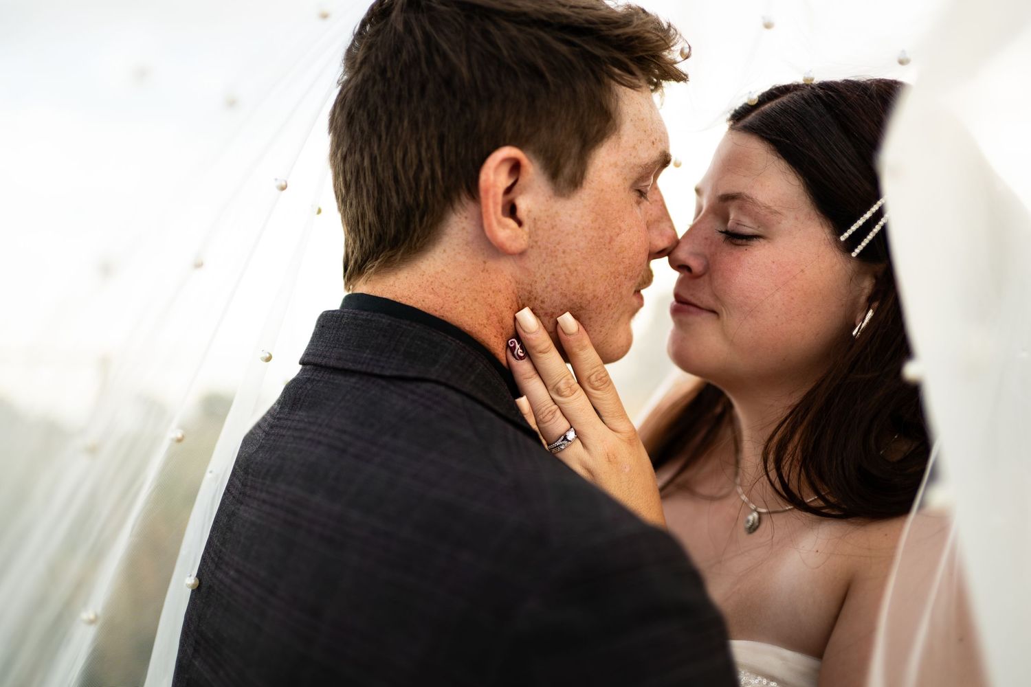 A romantic wedding couple shares tender moments in a series of intimate black and white photographs.