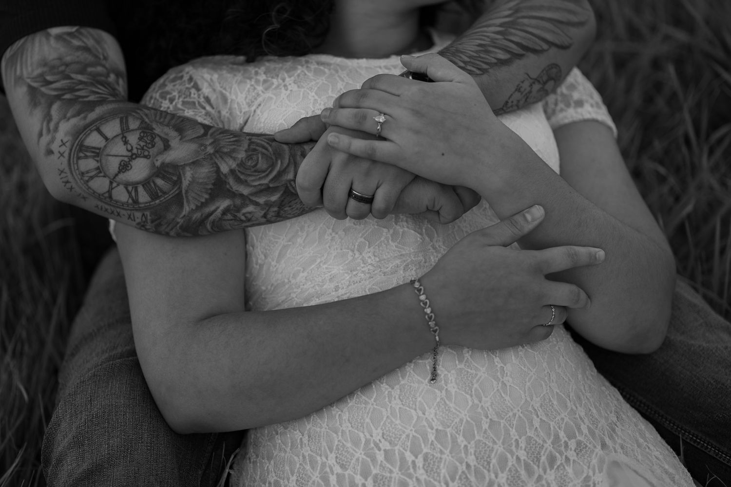 Black and white close-up photo showing a couple embracing during their wedding ceremony.