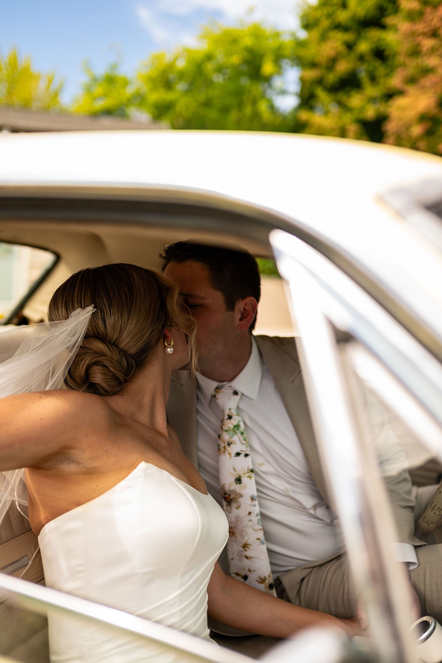 A romantic sequence of wedding photos showing a couple sharing an intimate moment in the back seat of a car.