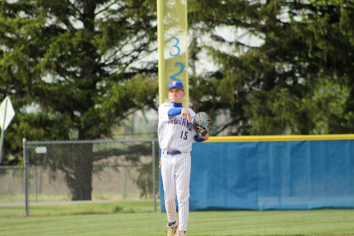 Triton H.S. (Bourbon) Varsity Baseball Player Levi McFarland throwing the ball from outfield.