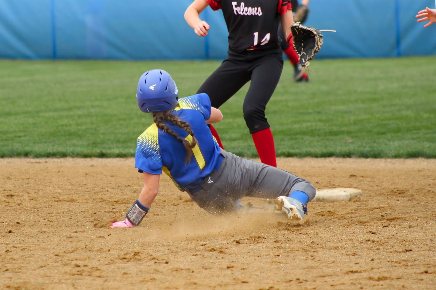Triton H.S. (Bourbon) Varsity Softball Player Kensie Schuh sliding into first base during a home game.