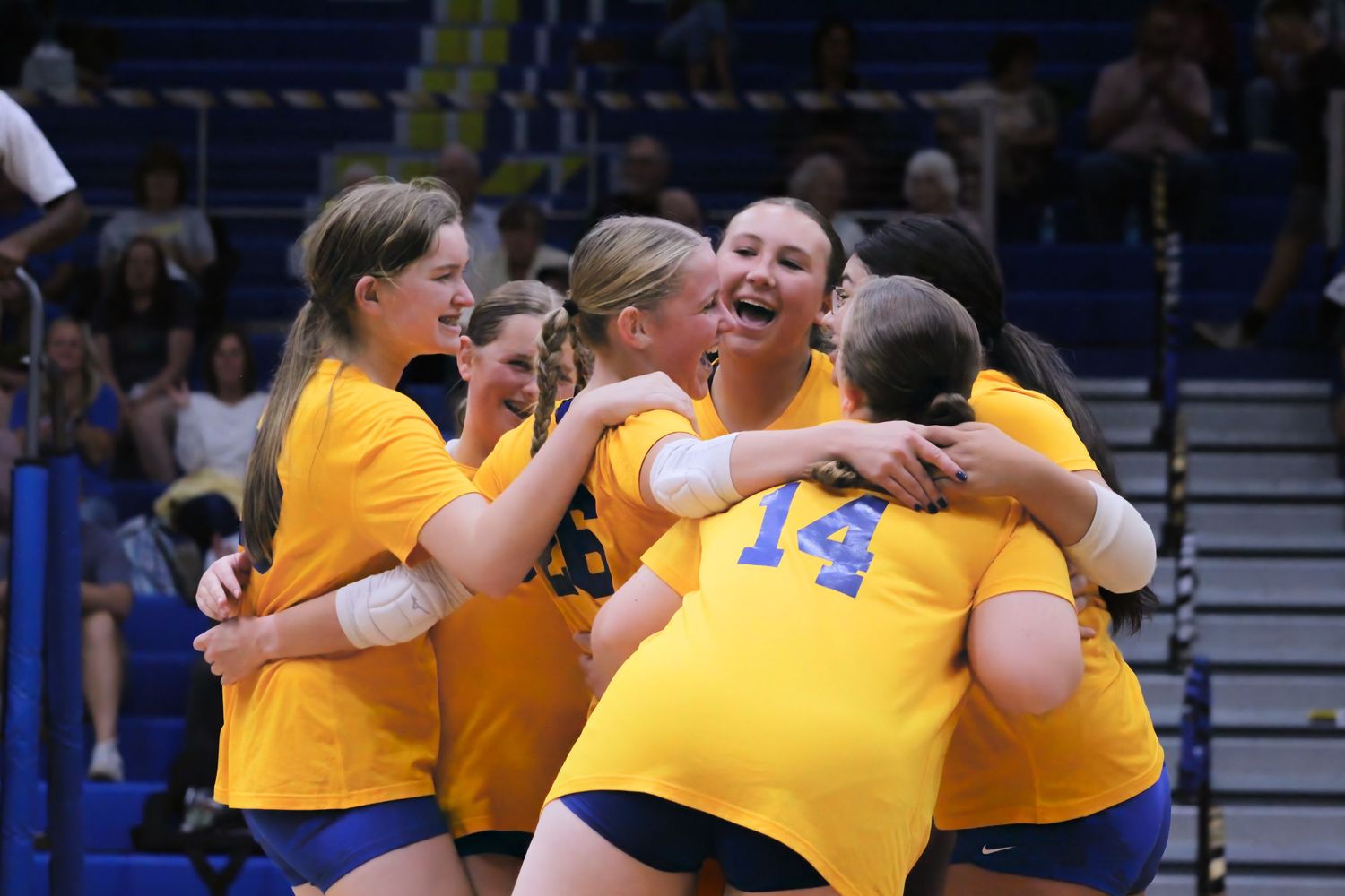 Triton H.S. (Bourbon) J.V. Girls Volleyball hugging after winning a set during a home game.