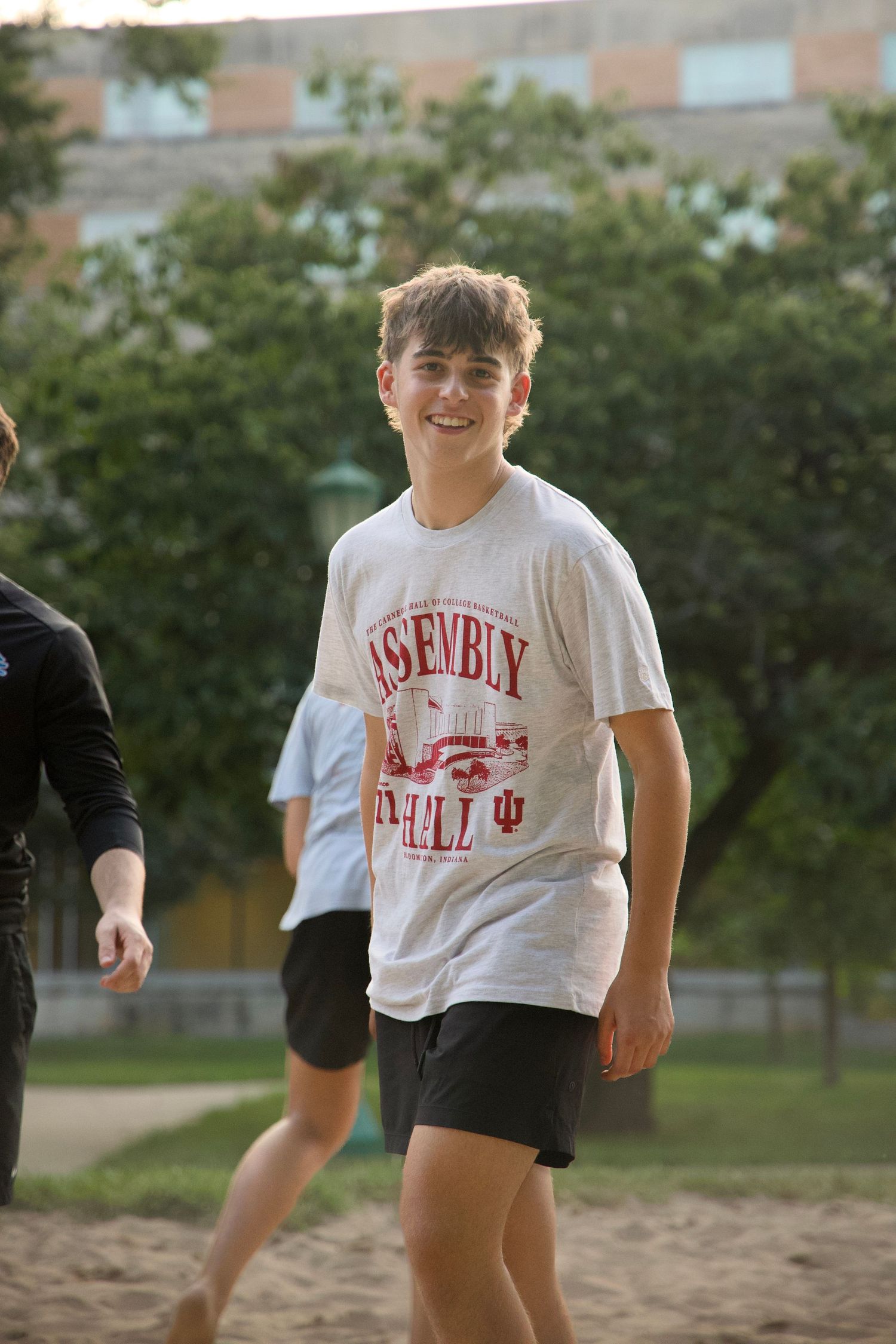 Indiana University HSJI's Adam Merzel smiling after a great play during a sand volleyball recreational activity.