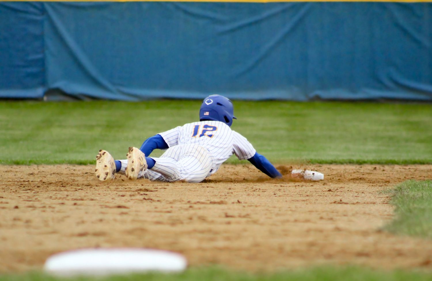 Triton H.S. (Bourbon) Varsity Baseball Player Jadyn Prater diving back to second base during a home matchup.