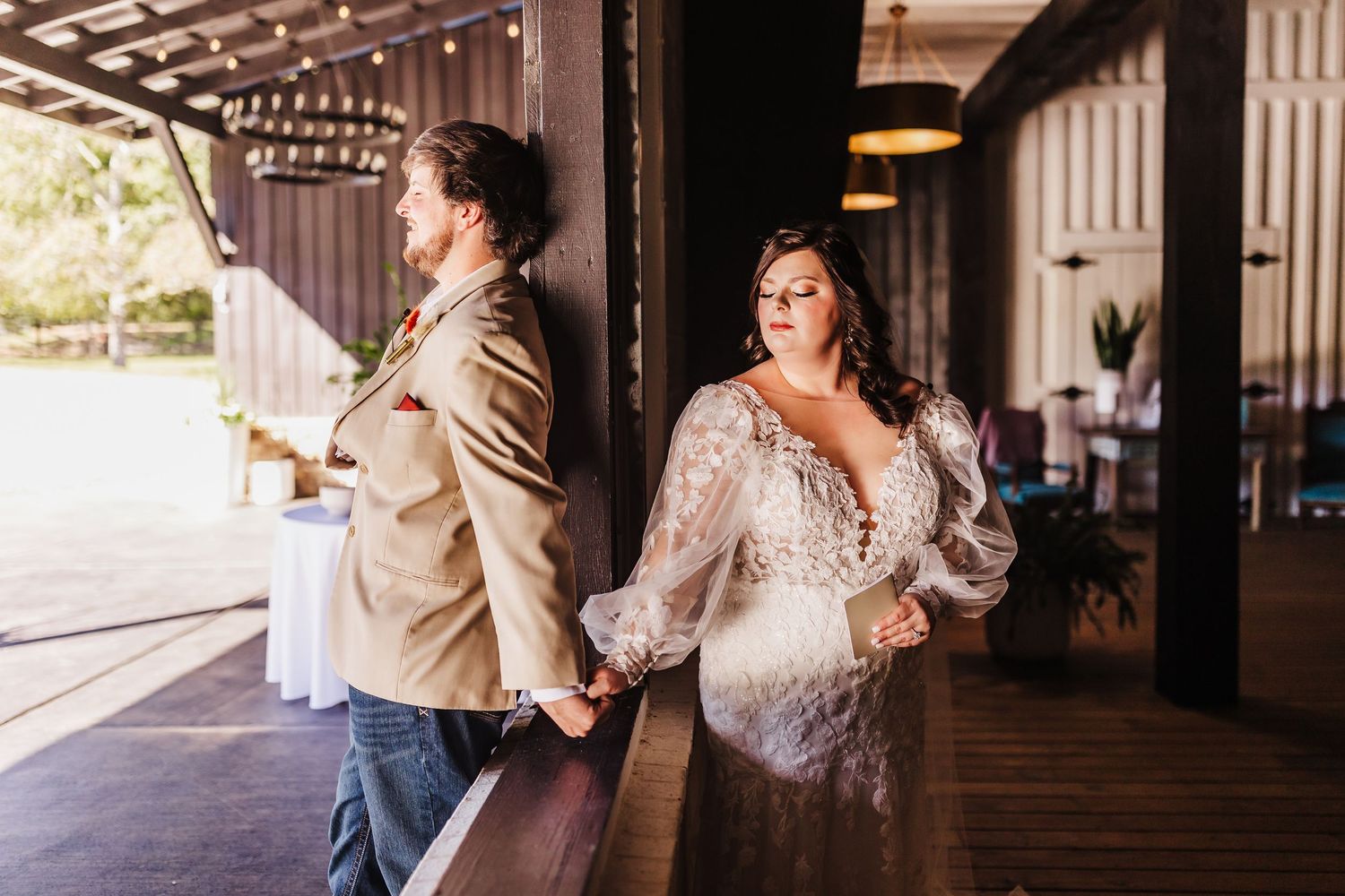 Bride and groom sharing private vows while touching from opposite sides of a wall before the ceremony at LL Farm Events Venue.