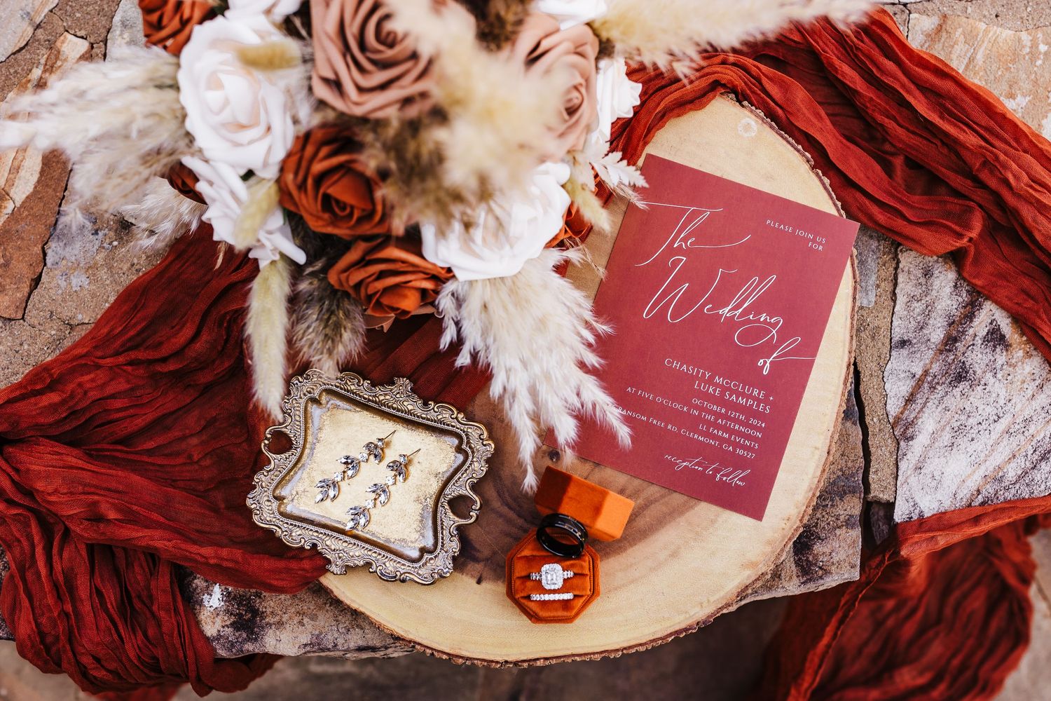 Wedding details featuring deep red decor, invitations and floral arrangements in a romantic vintage style.