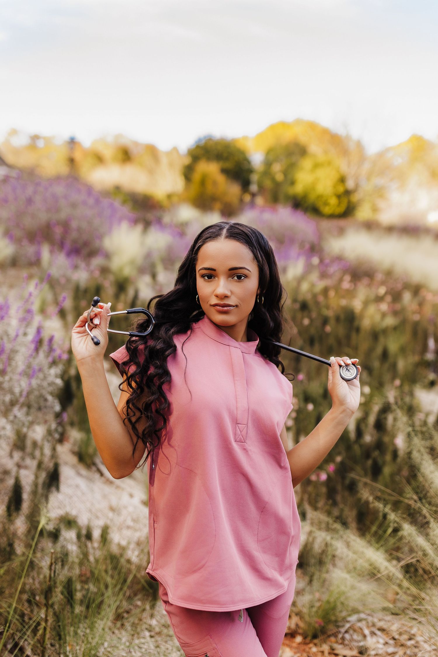 Lifestyle portrait of a nurse holding a stethoscope at the State Botanical Garden of Georgia.