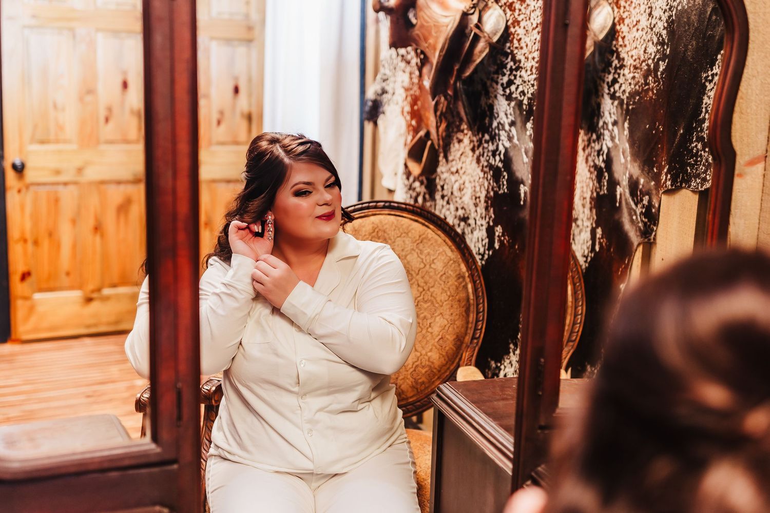 Intimate getting ready moment in an elegantly decorated room with vintage details.