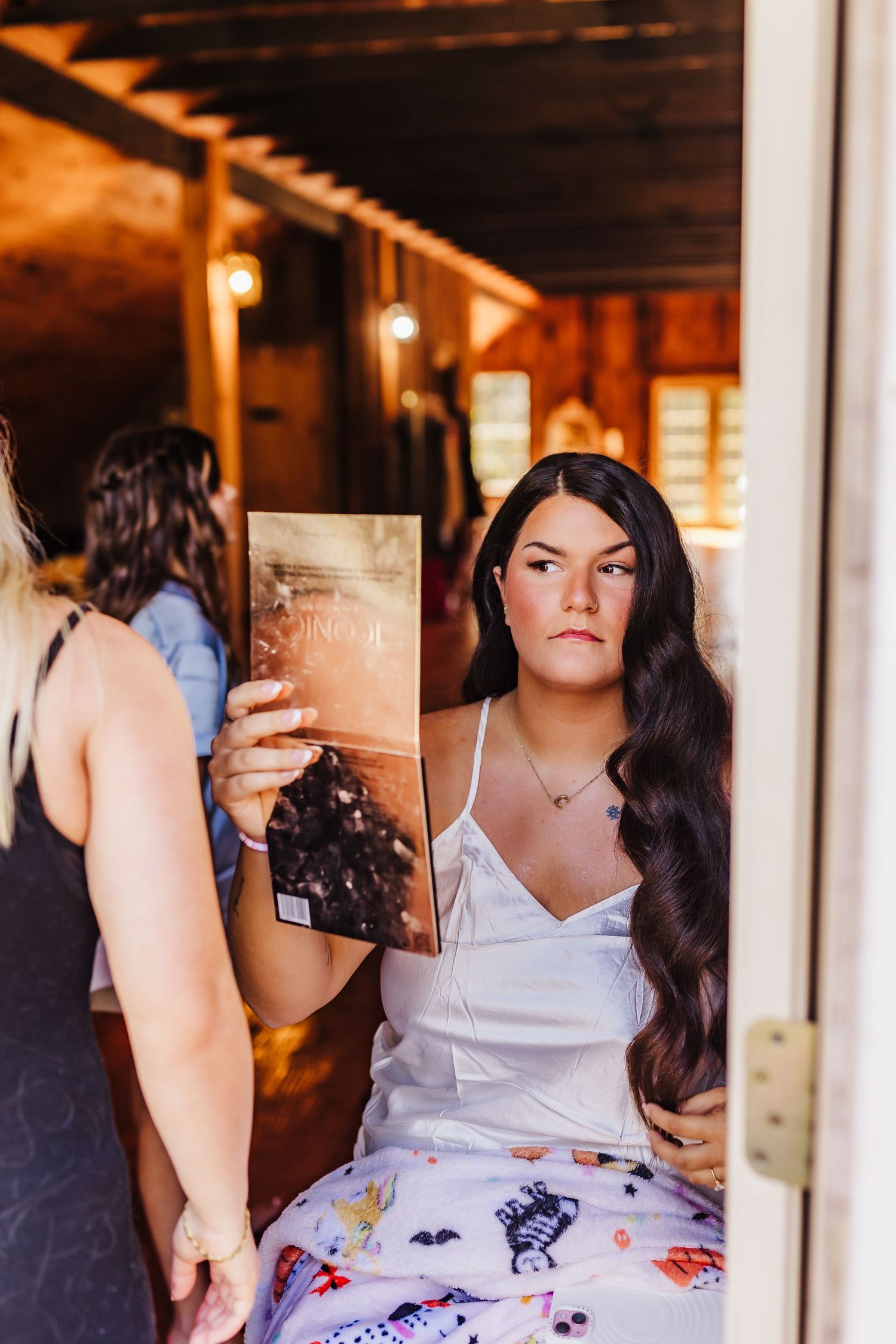 Artistic portrait featuring a book reflection in a rustic indoor setting.