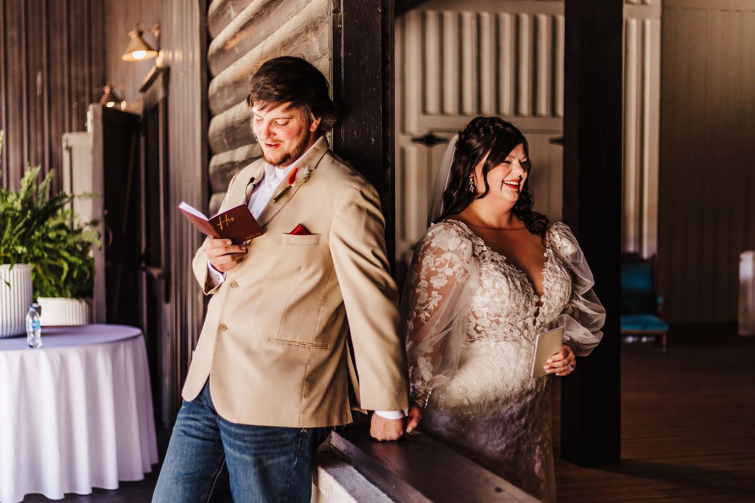 Bride and groom share a tender back-to-back moment, holding hands before their wedding ceremony.