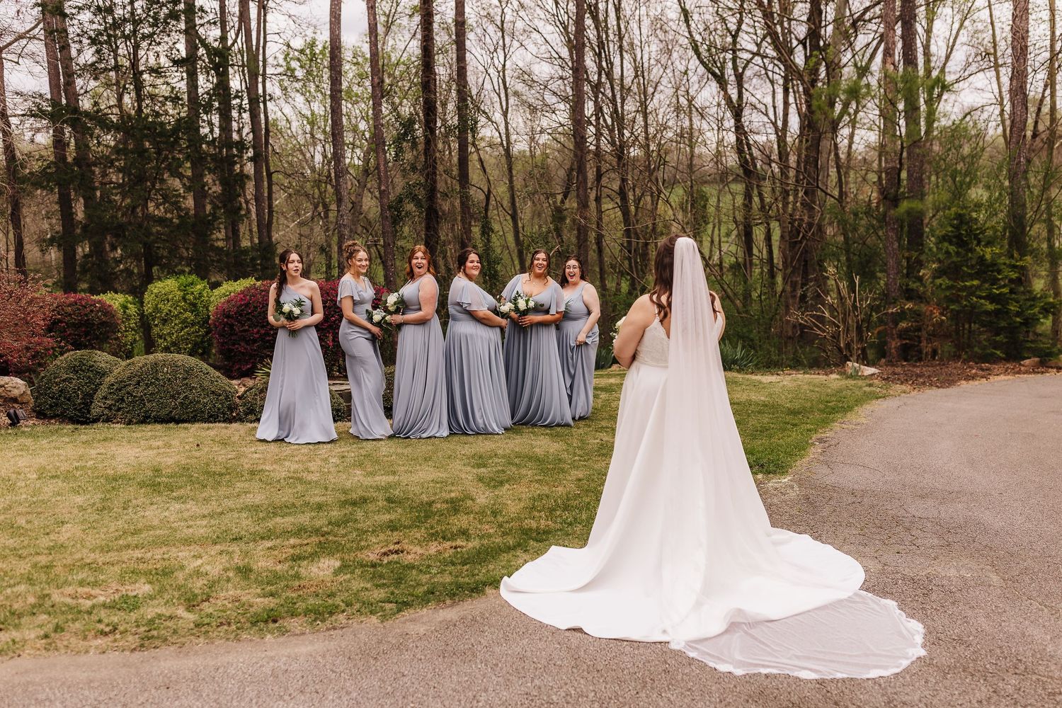 Bridesmaids seeing the bride for the first time during a wedding moment at Chapman Hill.