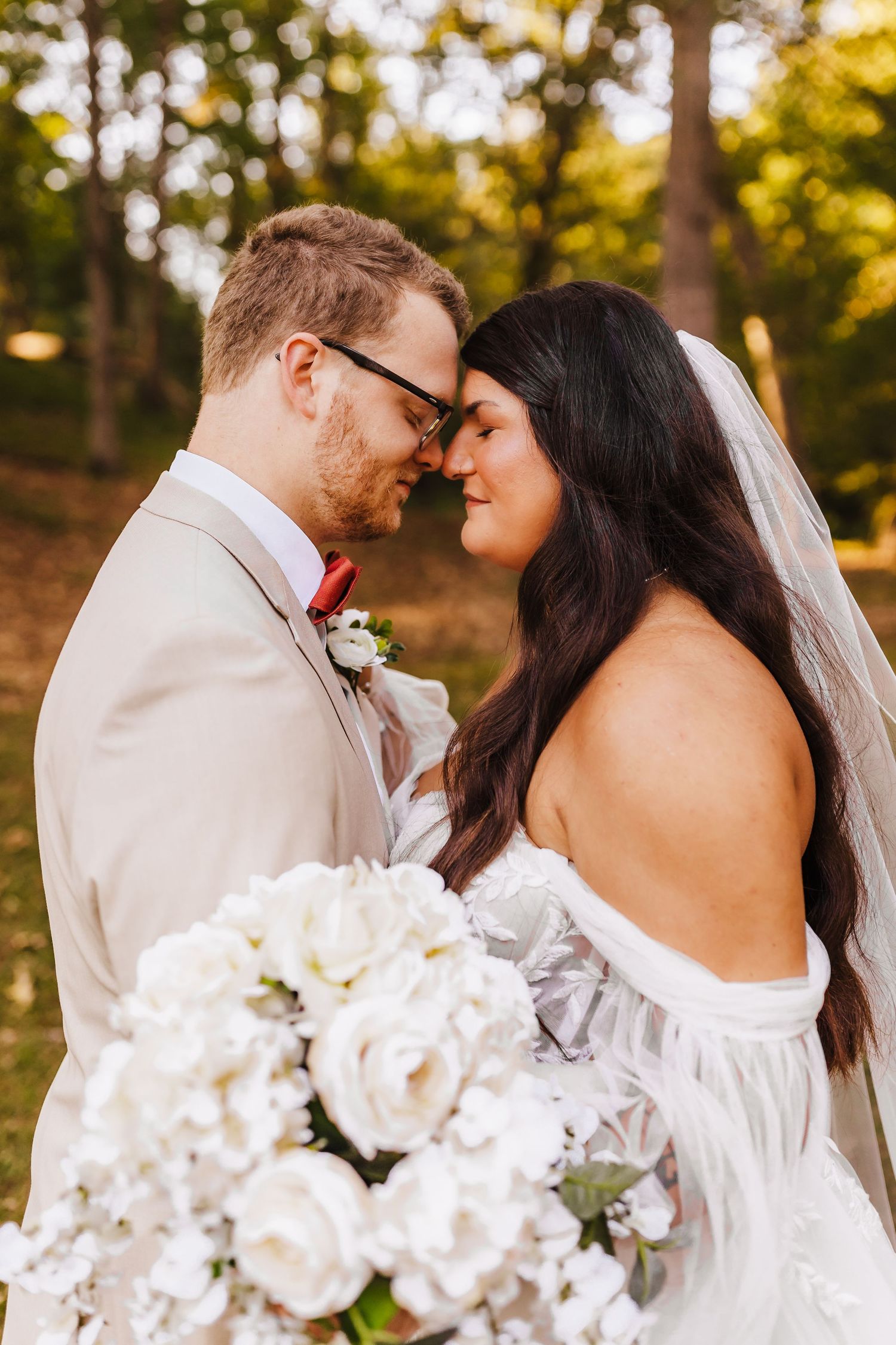 Elegant white floral bouquet featured in romantic outdoor wedding setting.
