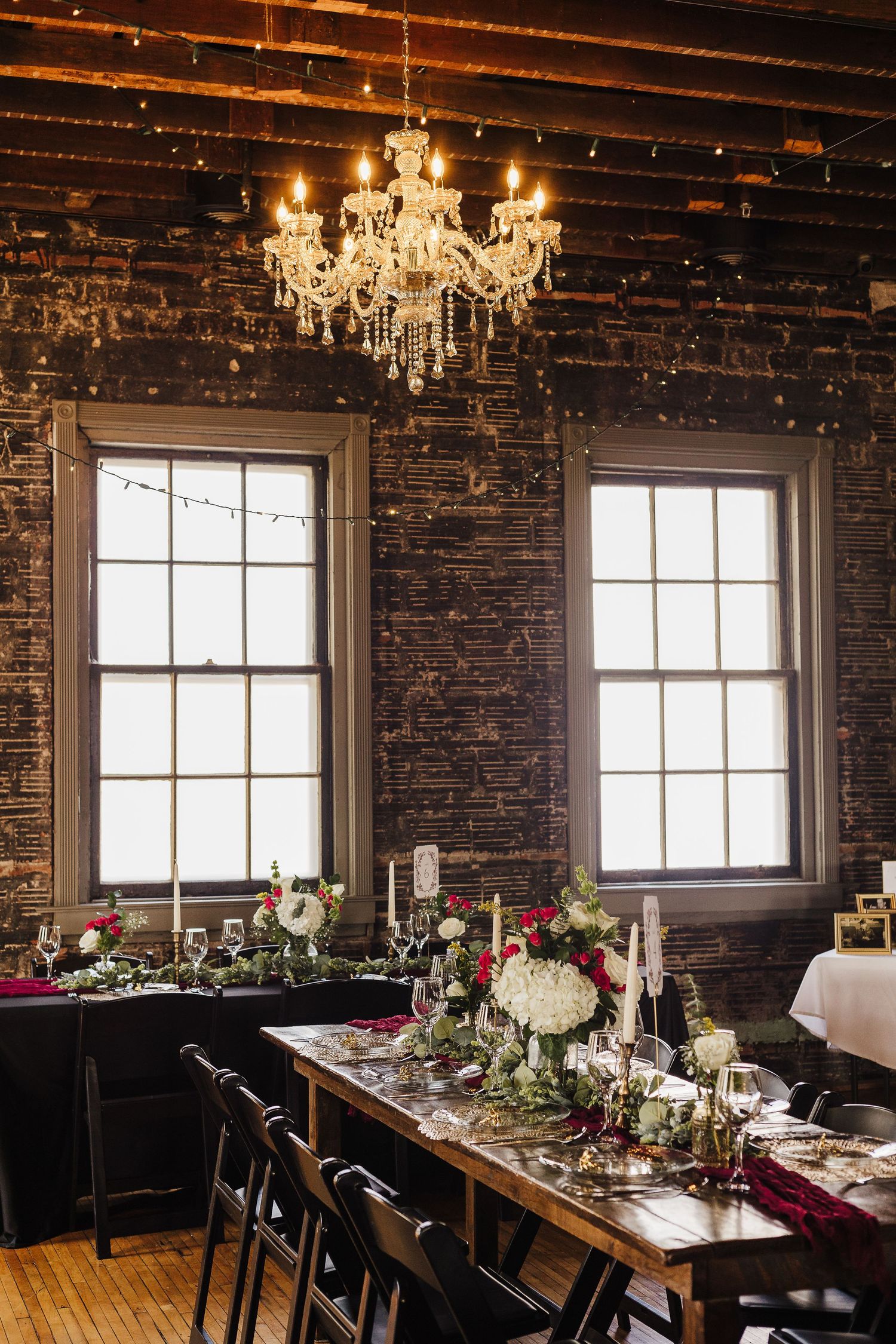 Indoor wedding reception space at New Holland Parlor featuring elegant tables and warm lighting.