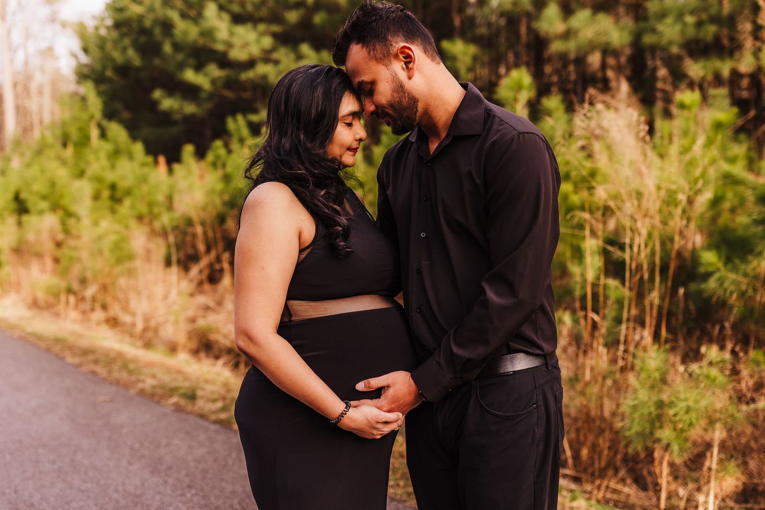 Maternity session featuring an expecting couple sharing a quiet moment during golden hour.