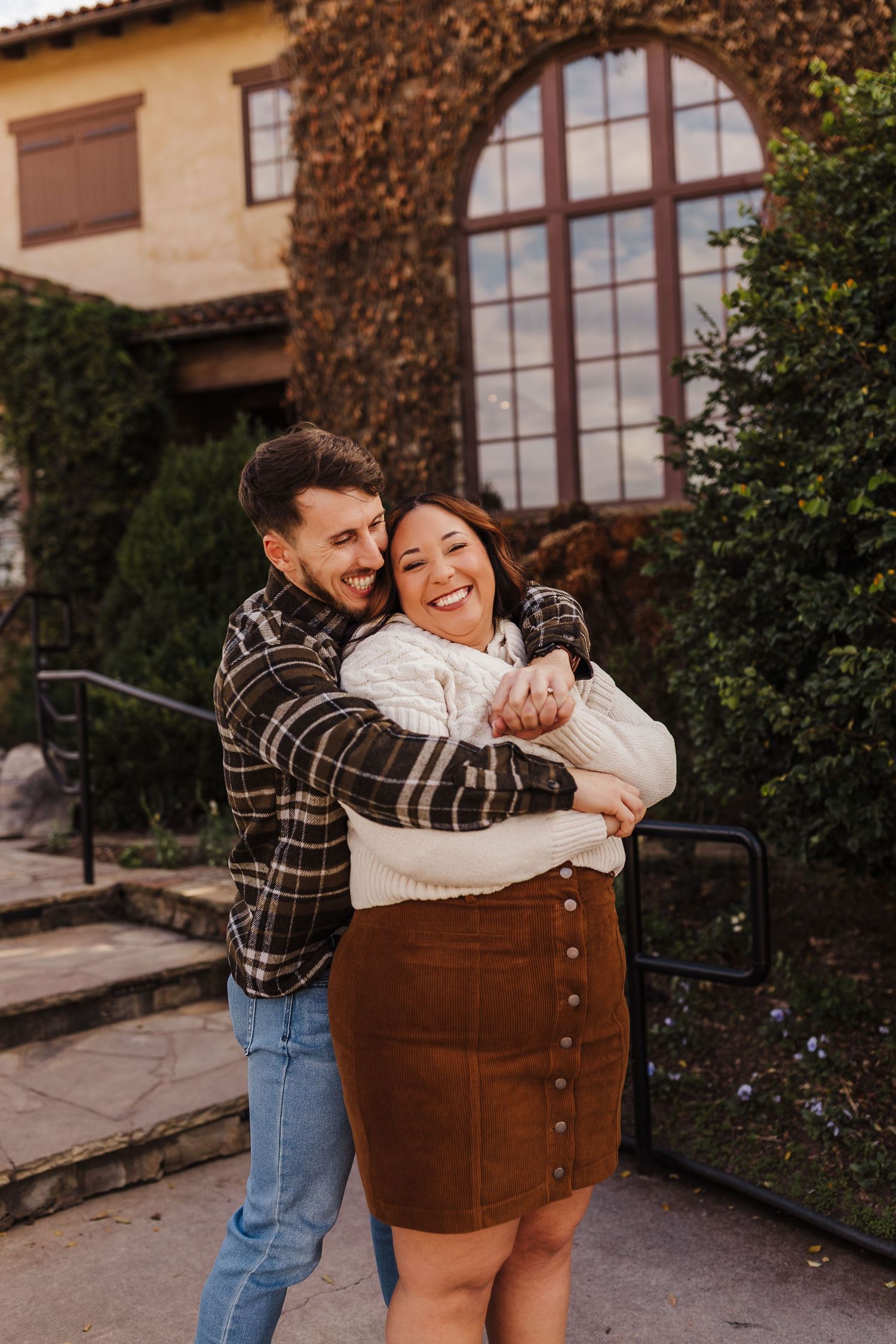 Couple laughing together during an engagement session at Montaluce Winery in North Georgia.
