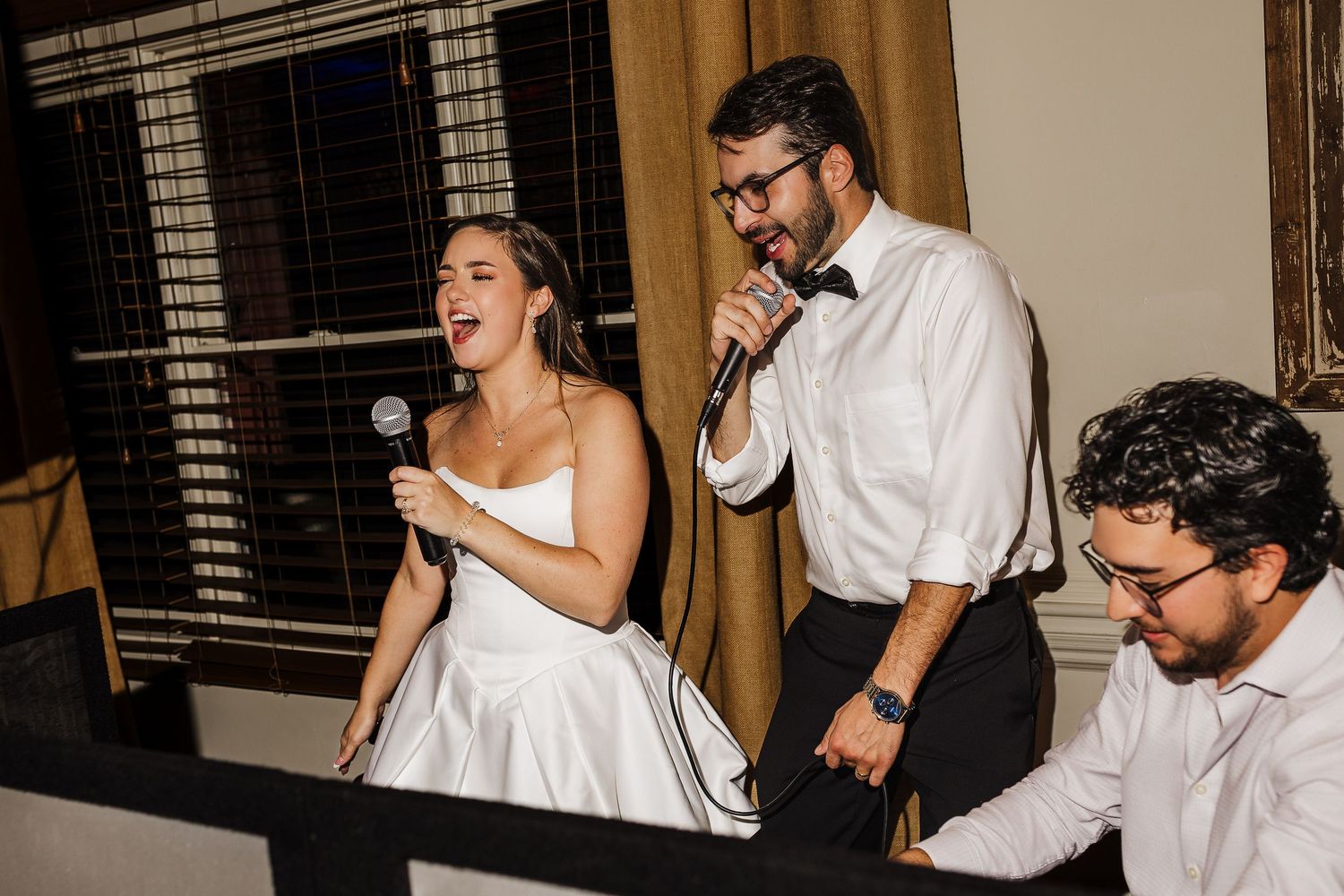 A couple shares a joyful moment together during what appears to be a wedding celebration.