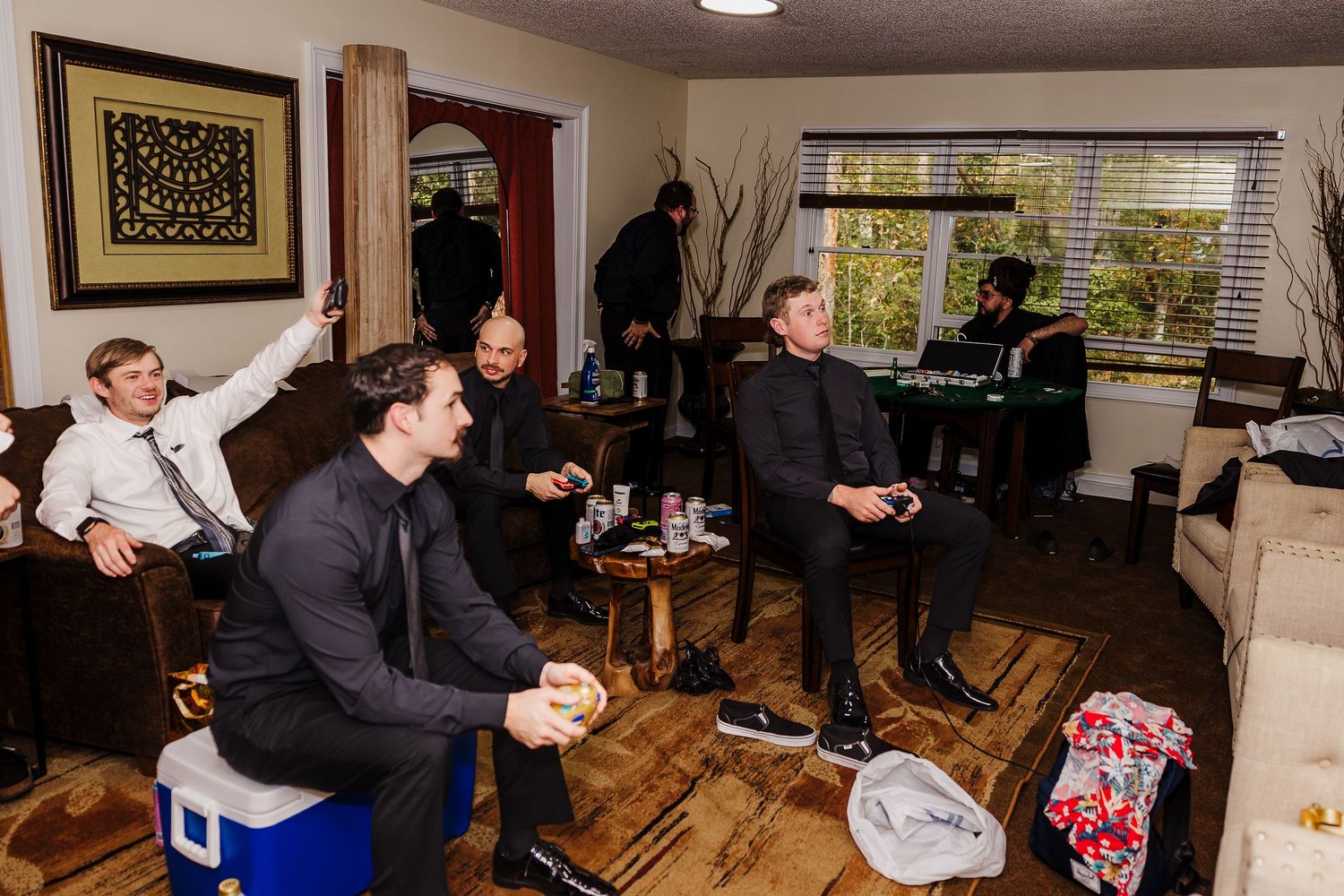 A panoramic view of people gathered in a living room during a social gathering or party.