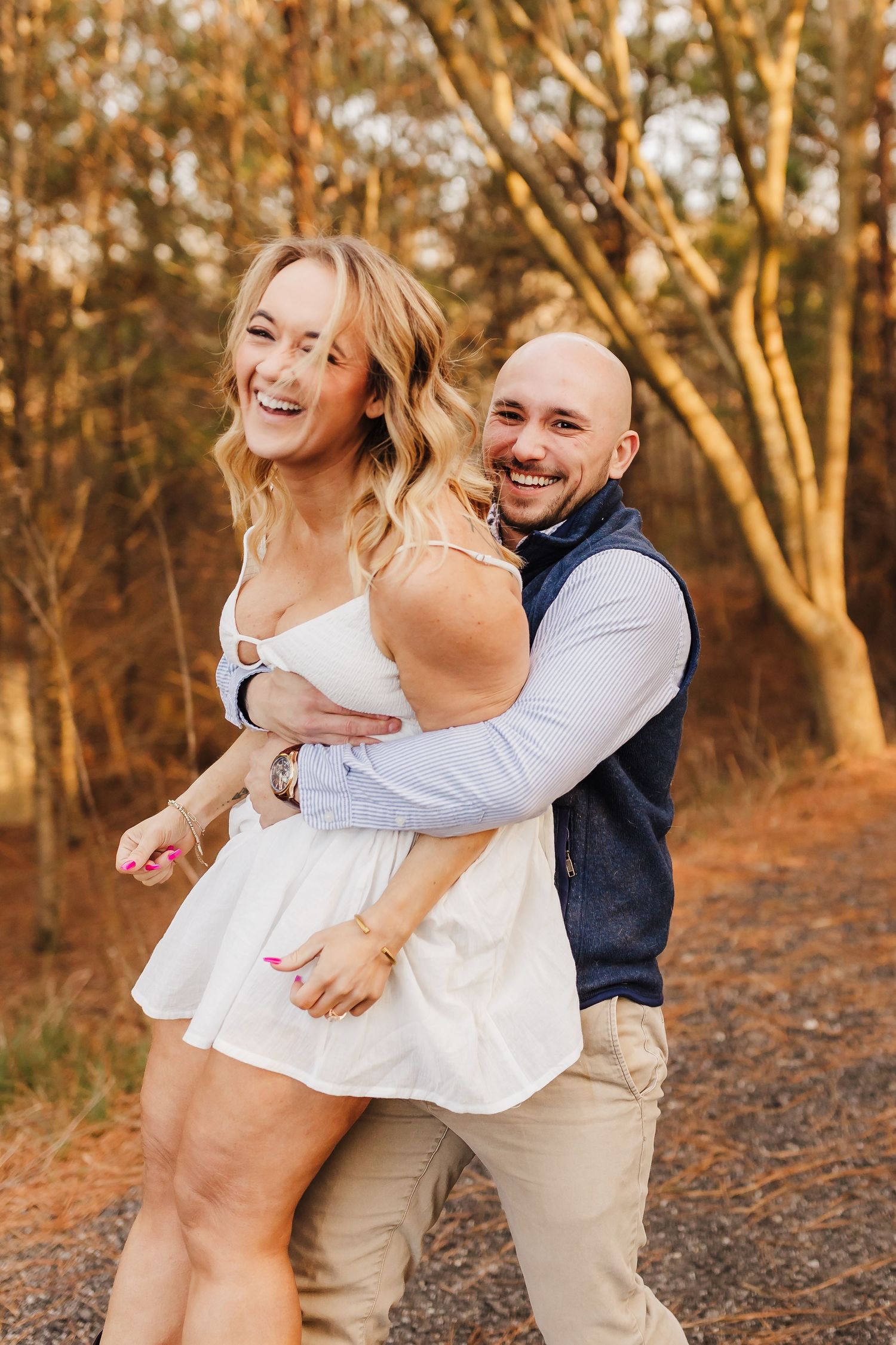 A playful outdoor photoshoot in golden autumn woods with casual attire.