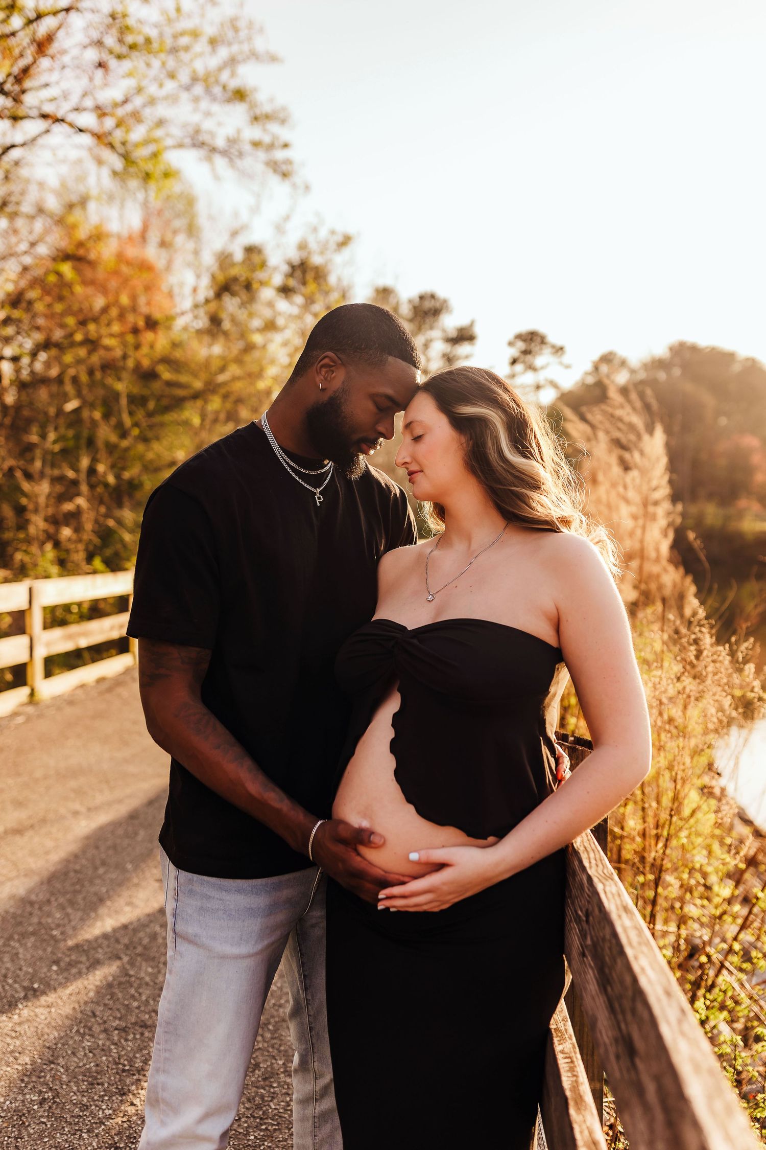 Outdoor maternity portrait of an expecting couple at Little Mulberry Park in Dacula, Georgia during golden hour.