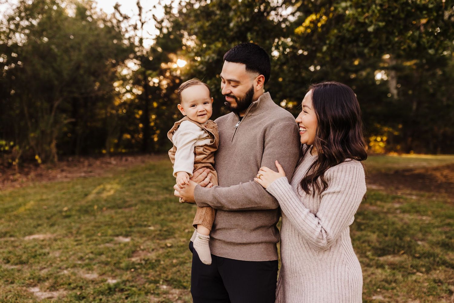 Family shares tender moment together during autumn outdoor photoshoot.
