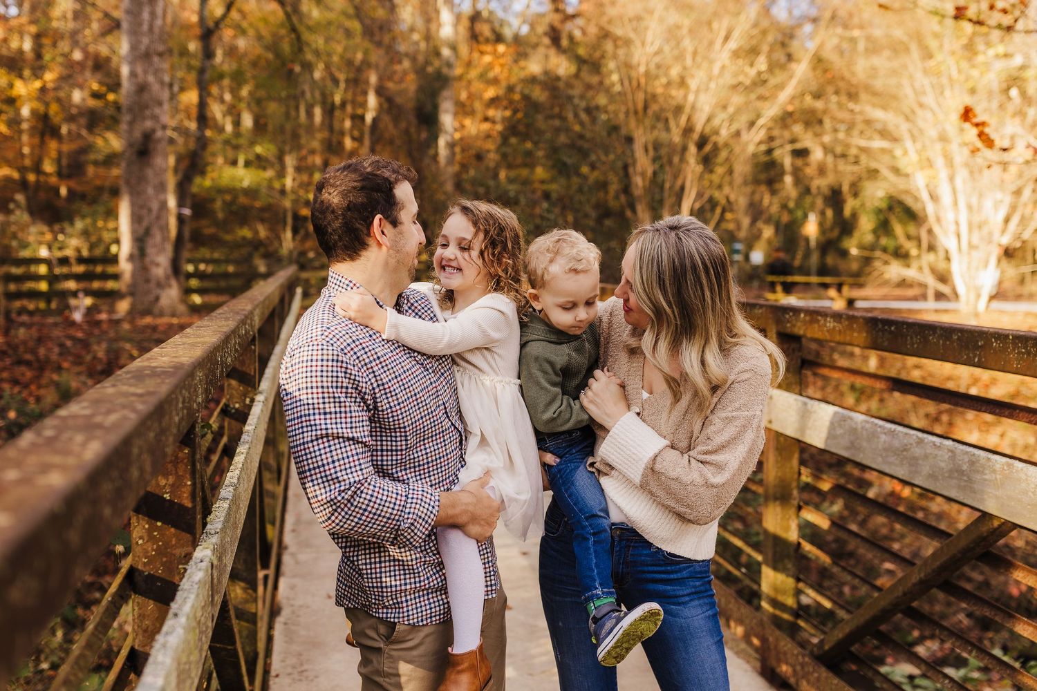Family sharing a joyful moment together during an outdoor family photo session at Harris Shoals Park.